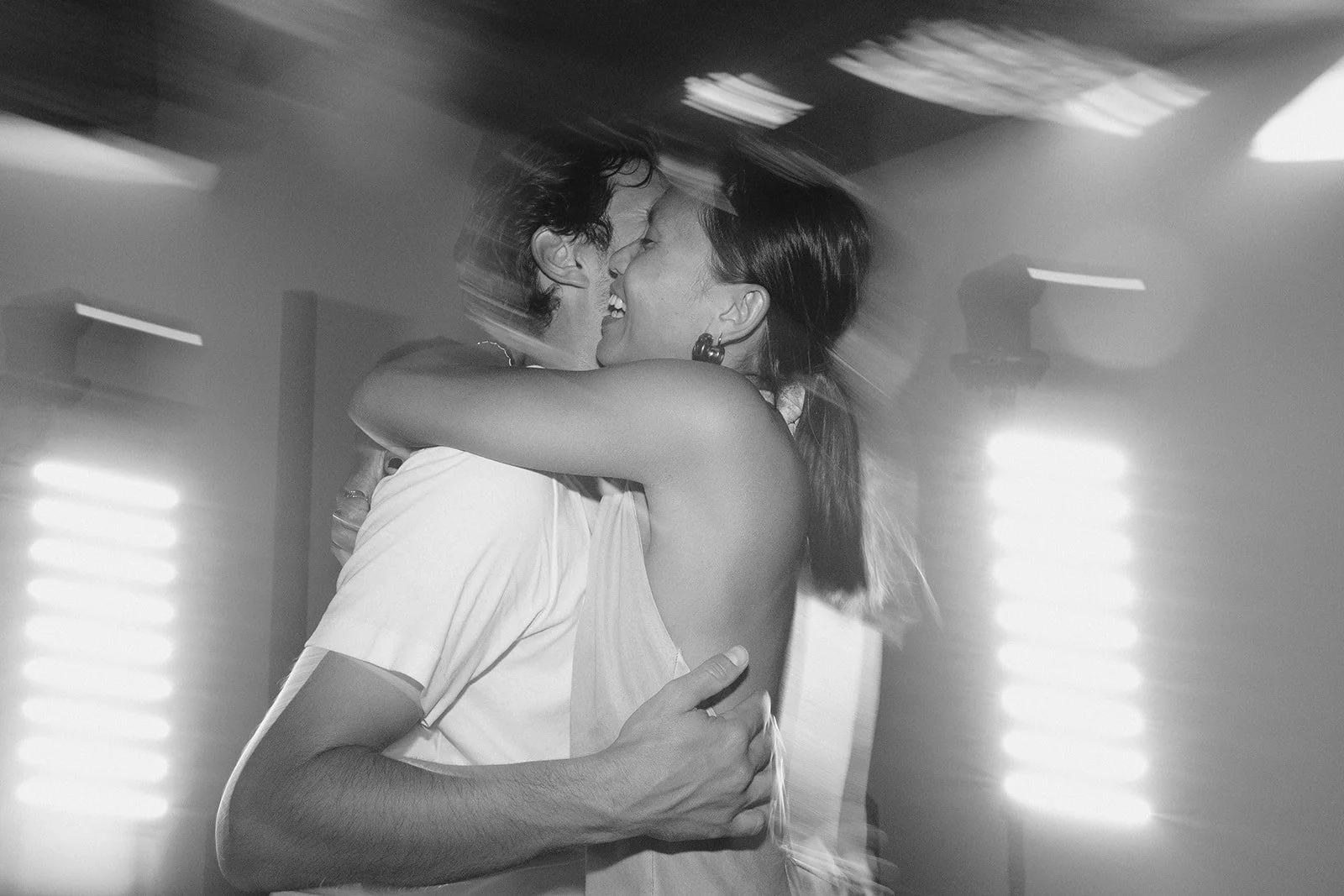 Photo d'un couple durant le dancefloor pendant la soirée d'un mariage, avec flou de mouvement
