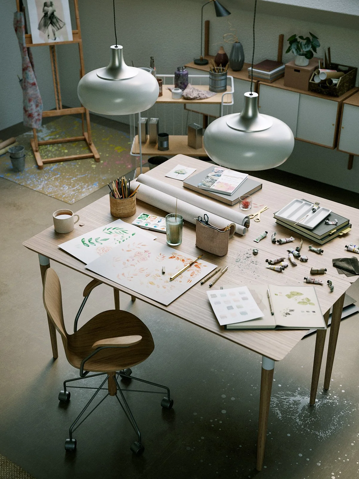 A creative workspace with a wooden table cluttered with watercolor paintings, art supplies, and a cup of coffee, illuminated by large pendant lights, set in a room with shelves and a painting easel.