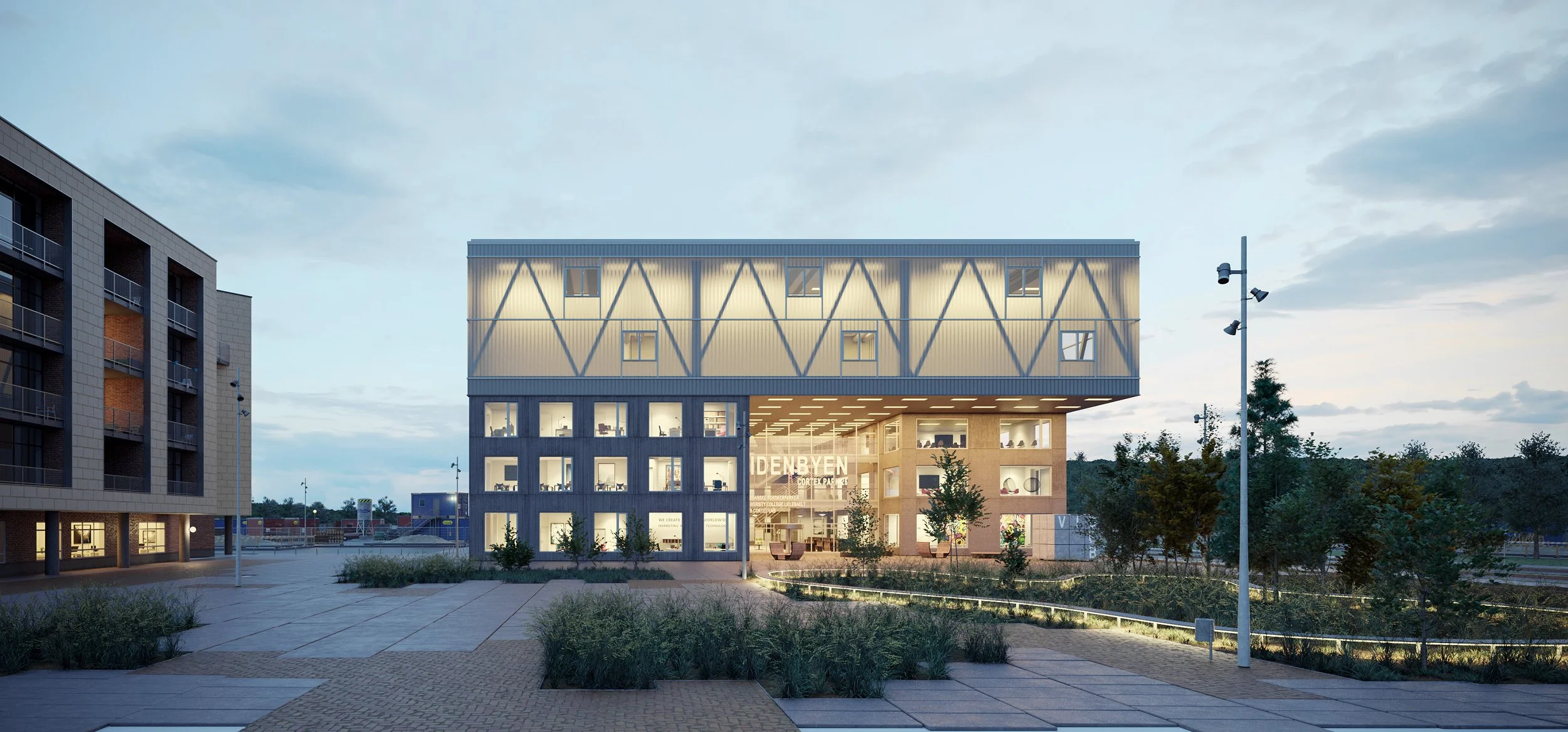 Modern multi-story building with illuminated ground floor, trees, walking path, and street lights at dusk.