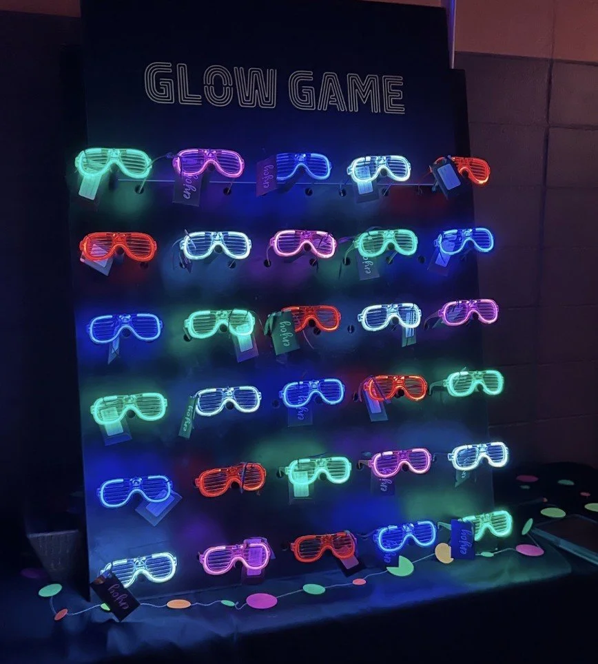 glowing neon glasses are part of a glow game at an auction event