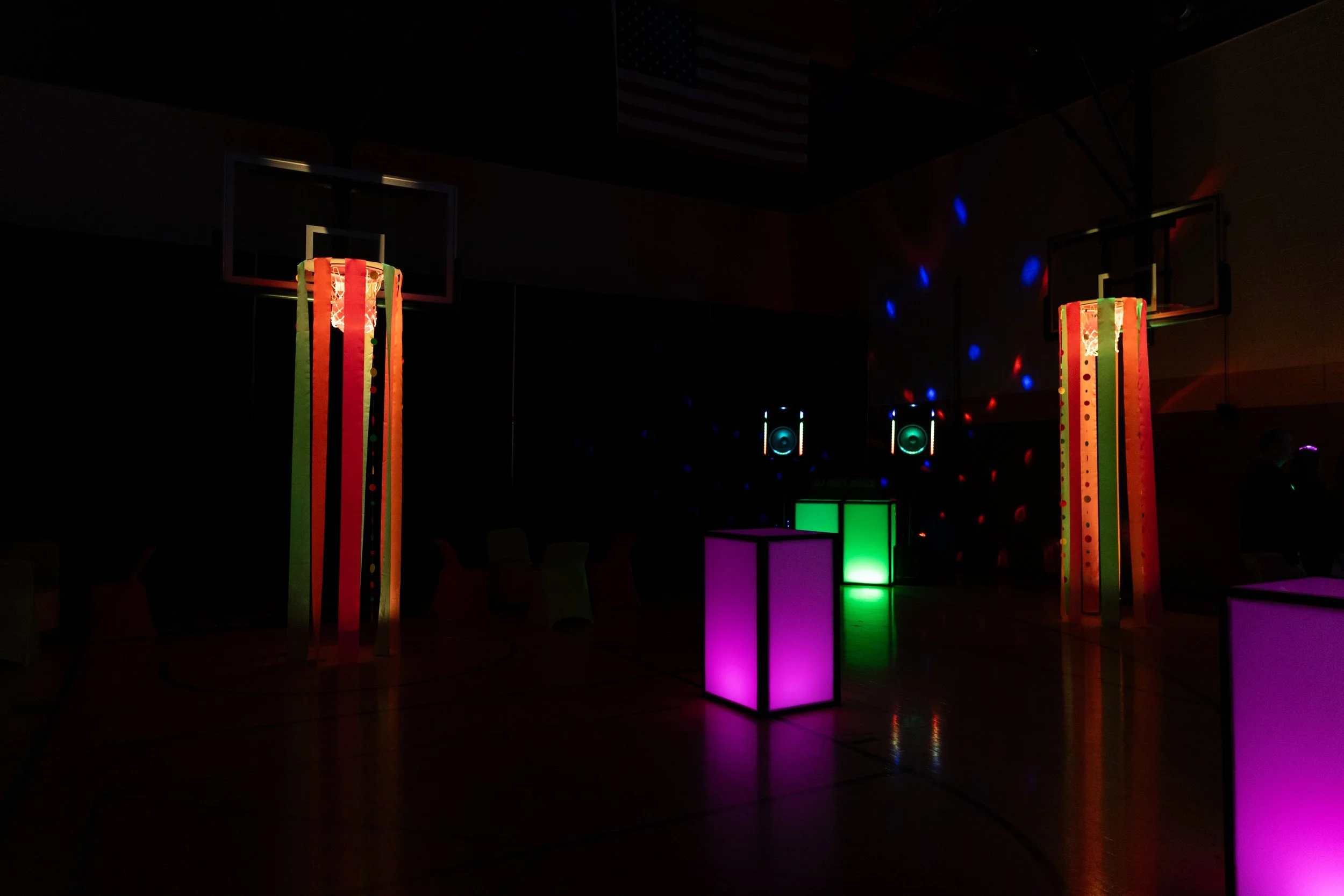 glowing tables and room decor at neon auction event