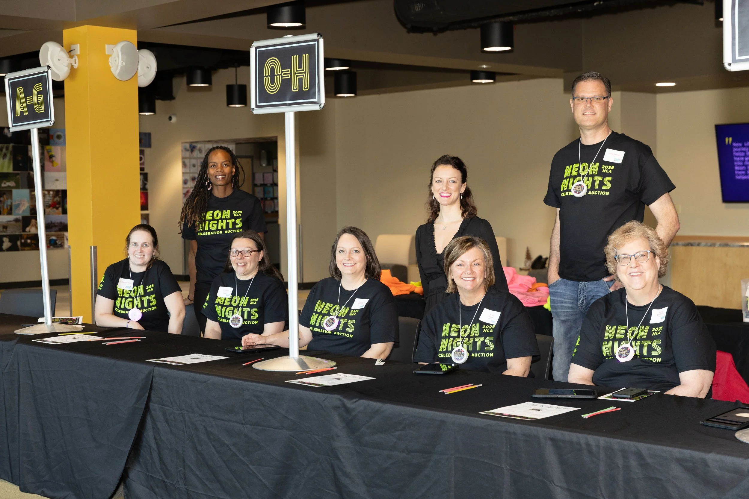 volunteers helping with check-in at auction event