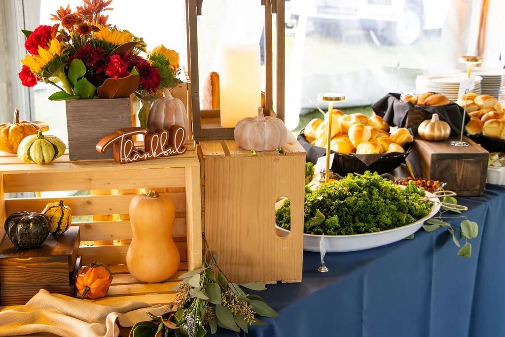 Dinner buffet table with fall decor flowers and gourds