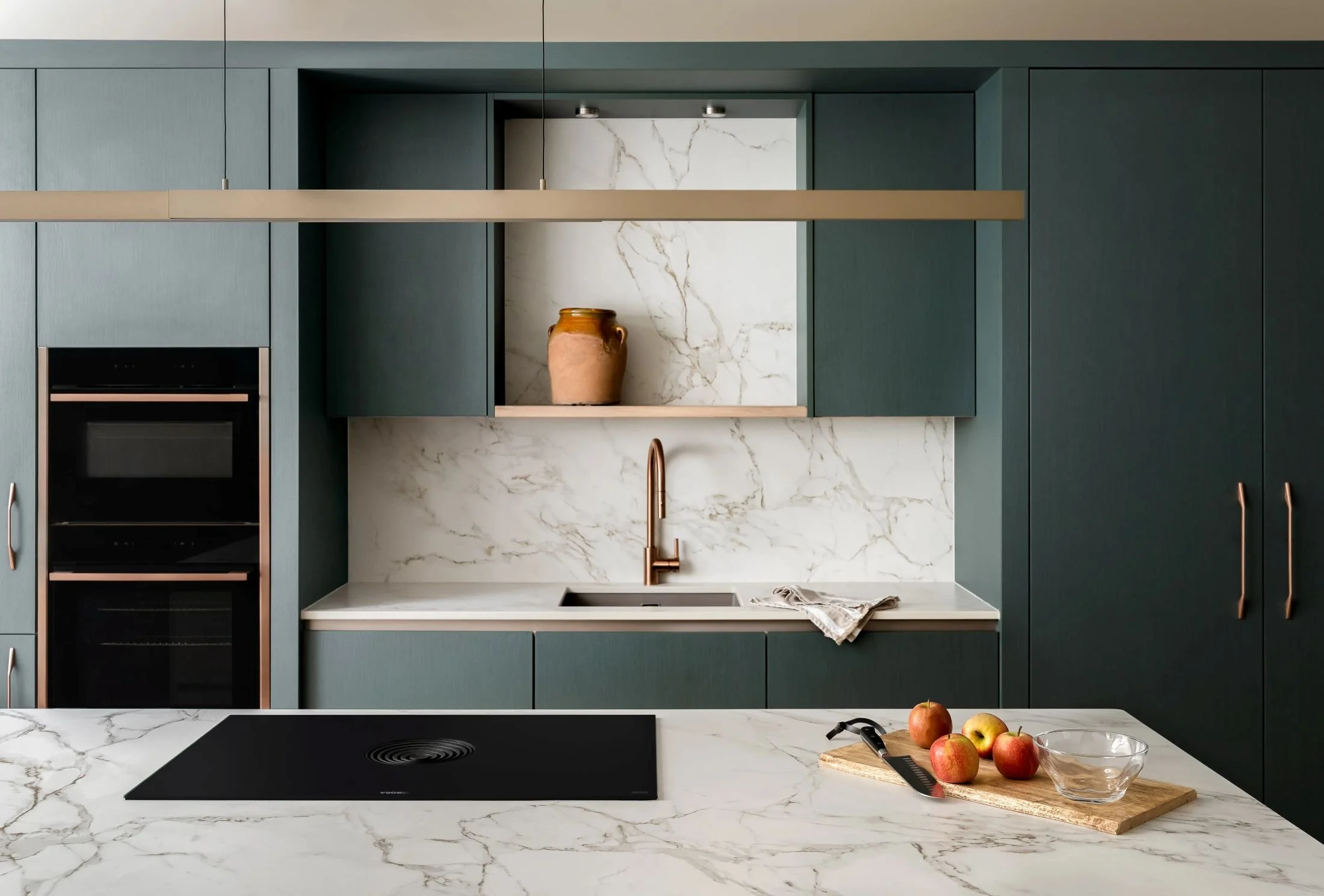 Modern green kitchen with marble worktops, brass details and integrated cabinetry by South Hill Studio in Kilkenny.