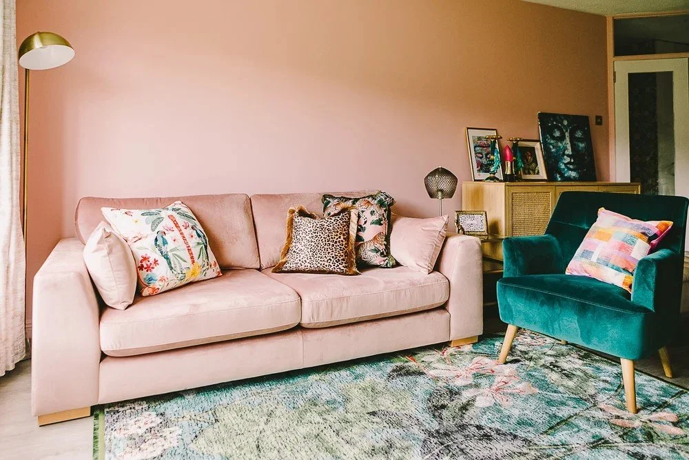 Sitting room in a Terenure garden apartment featuring a soft pink sofa and green accent chair, designed by South Hill Studio.