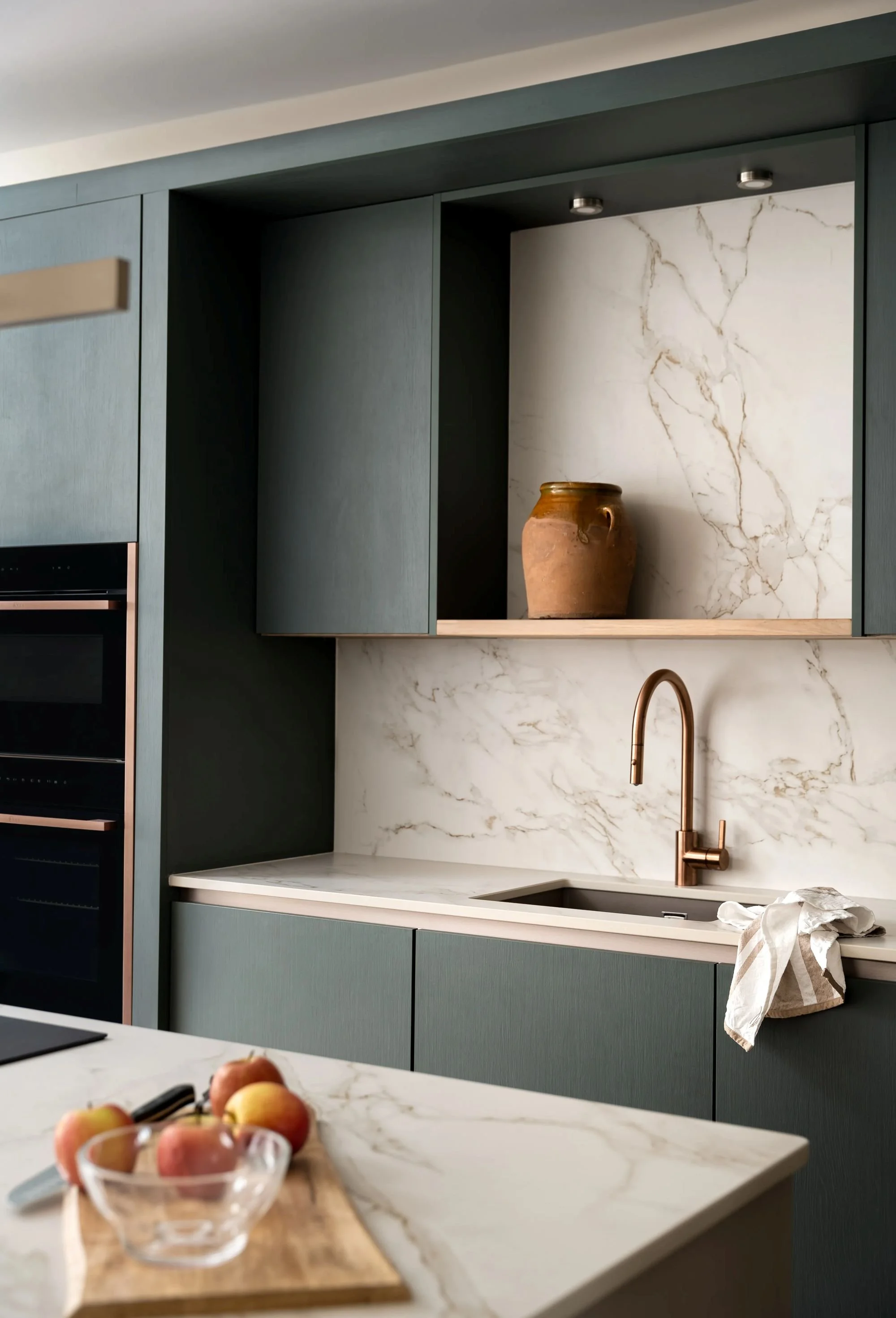 Modern green kitchen with marble worktops, brass tap and textured cabinetry by South Hill Studio in Kilkenny.