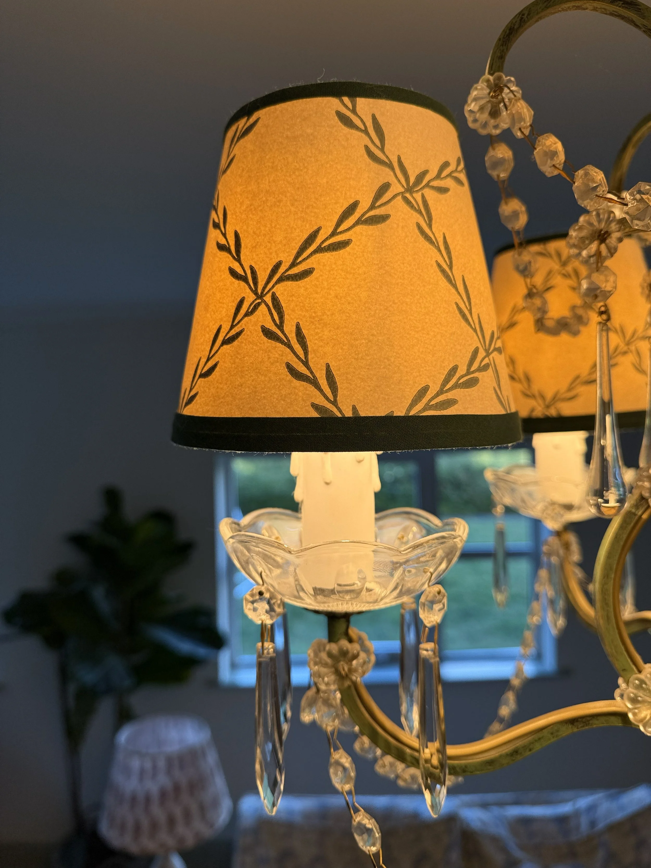 A bespoke lampshade for chandelier made from Sandberg wallpaper and green bias tape