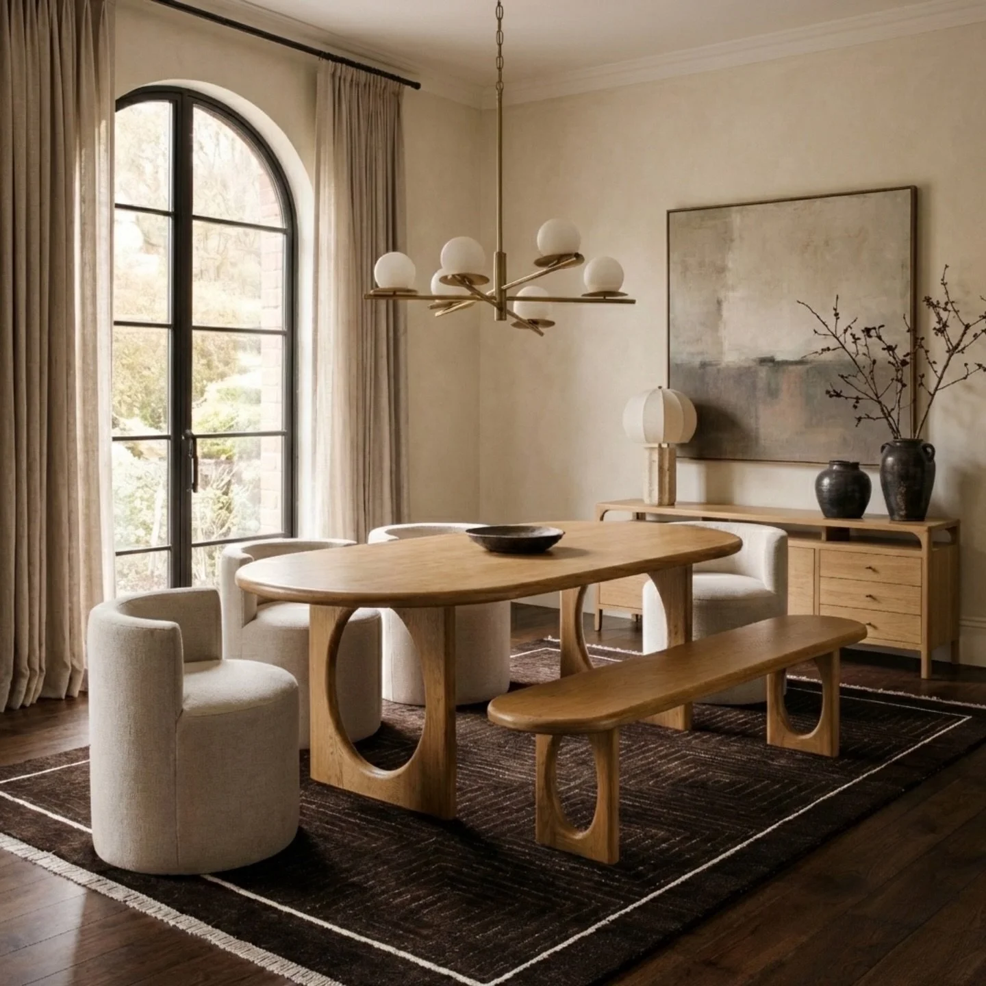 A sculptural mix: Our Eva Dining Table and Bench, Leona Dining Chairs, Cali Sideboard in natural and our Barcelona Rug &amp; Riviera Table Lamp from our Button Atelier x Co.House Designs Collection. 

Find it all at cohousedesigns.com