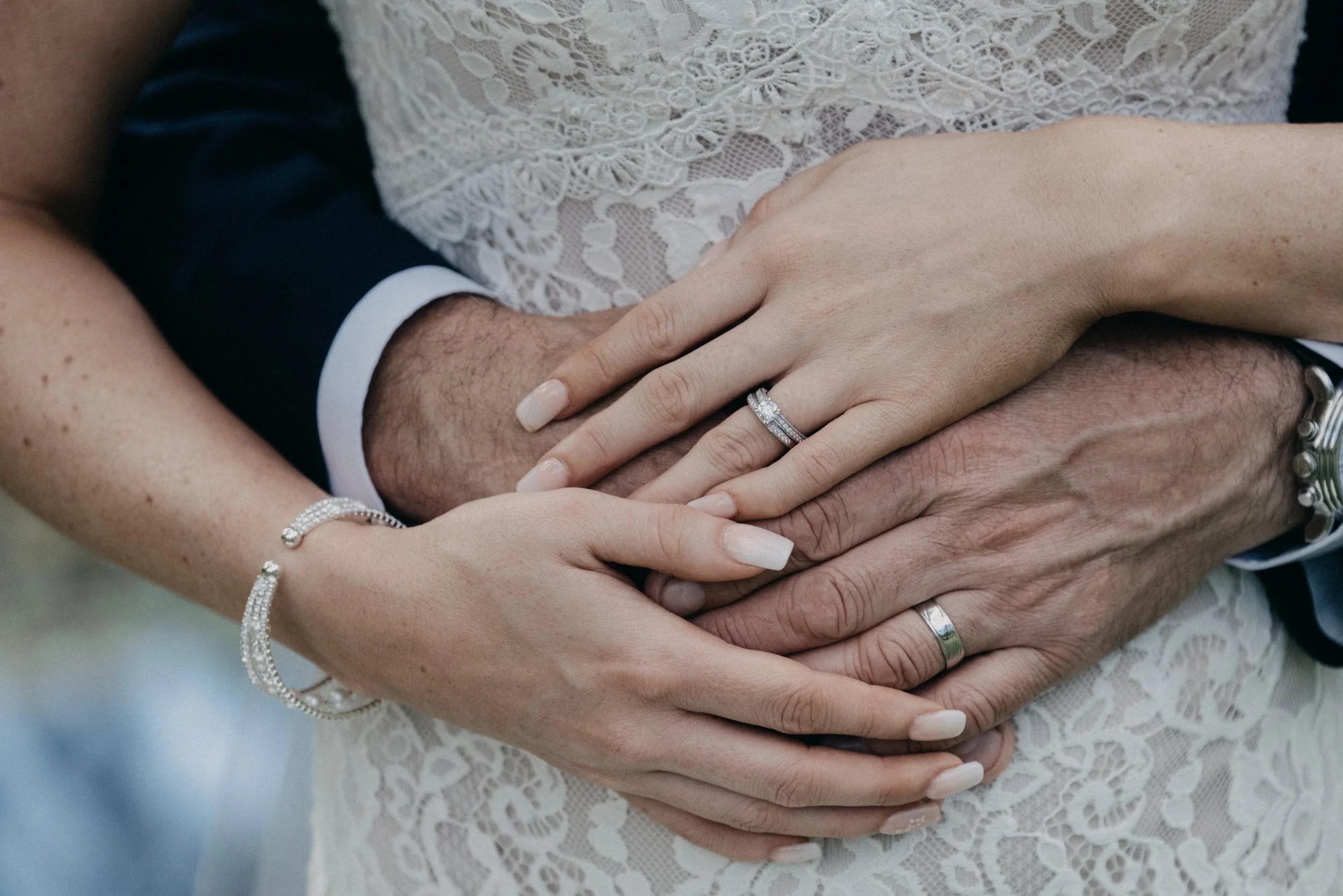 Close-up of a couple’s hands showing their wedding rings after an intimate Blue Mountains elopement, symbolizing love and connection.