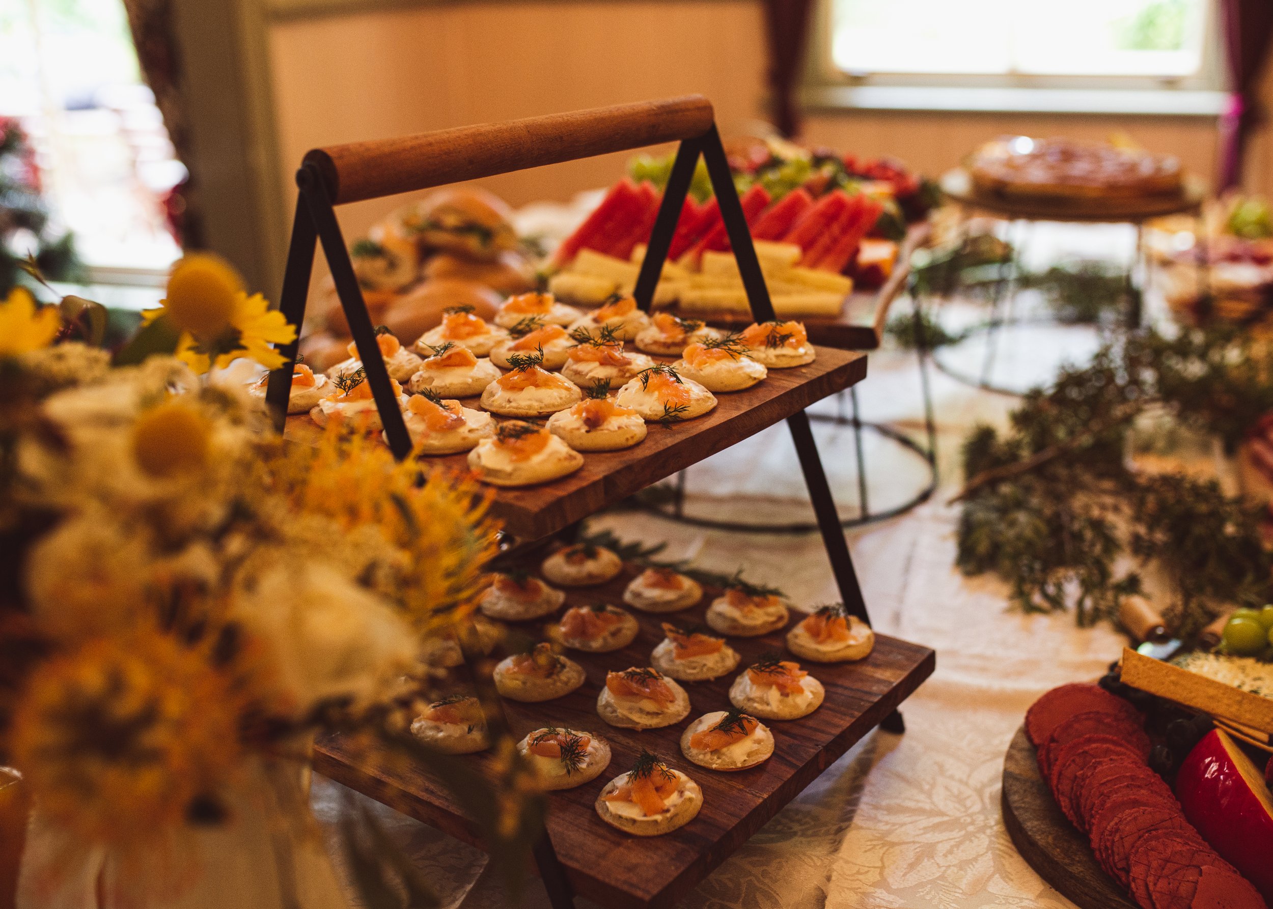 A rustic wooden tray filled with elegant appetizers — the perfect catering detail for a boutique Blue Mountains elopement celebration.