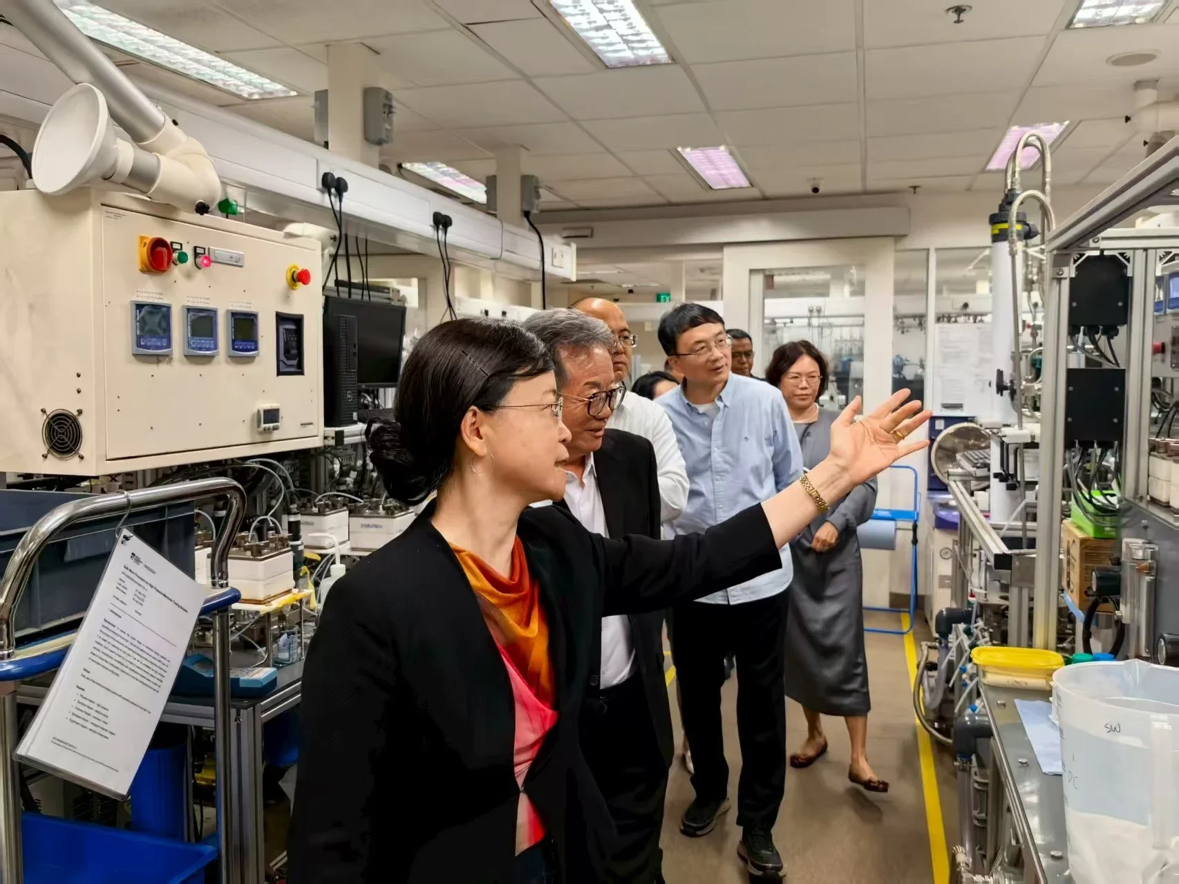 Prof. Wang Rong guiding the delegation through the membrane technology laboratory at SMTC, showcasing ongoing research and pilot-scale systems.
