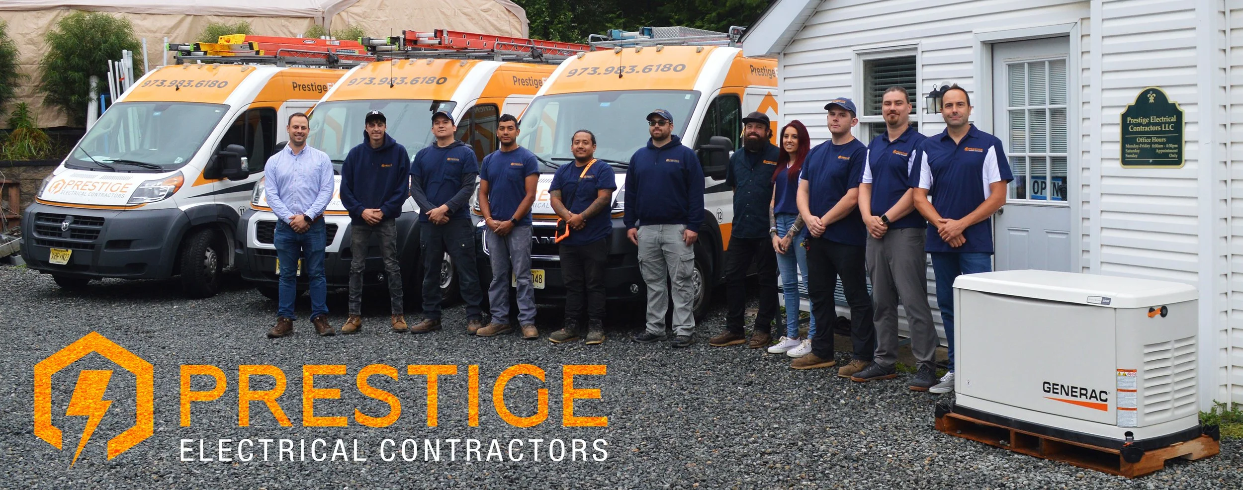 A group of electrical contractors standing in front of branded service vans and a generator outside a building with a sign for Prestige Electrical Contractors LLC.