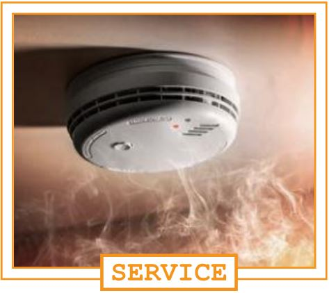Smoke coming from a ceiling-mounted fire alarm or smoke detector.