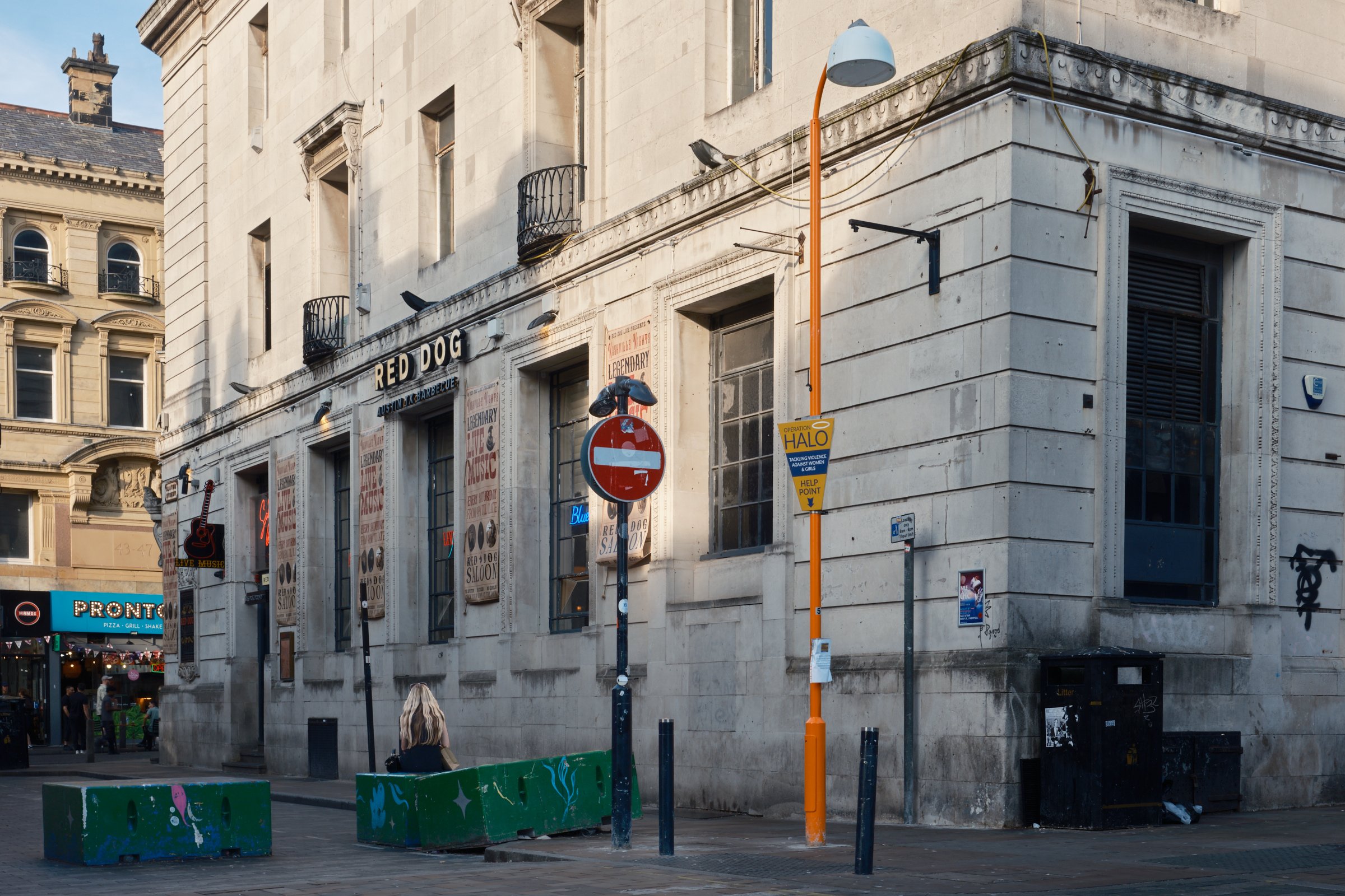 01 - Extended Frame: Under Watch.
"A woman occupies public space within a wider environment of observation and potential vulnerability. The image invites consideration of what it means to feel safe in public, and of the unseen social conditions that 