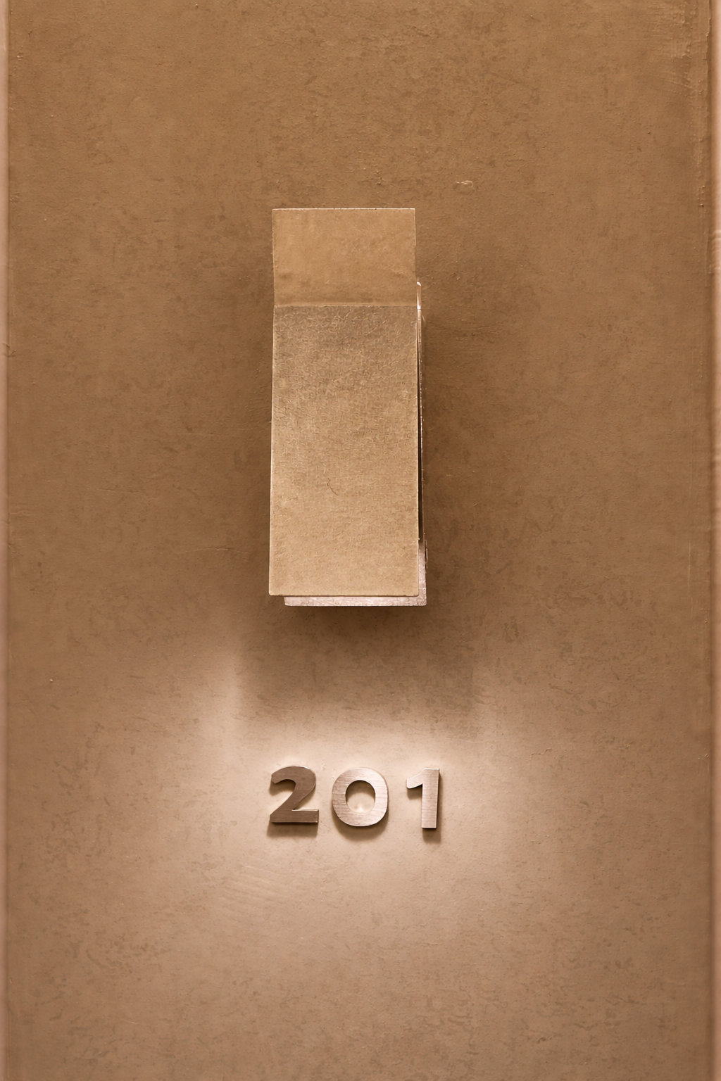A warm-toned willow leaf stay Gangnam room door featuring a brushed-metal wall lamp illuminating the metallic room number 201 on a textured beige wall.