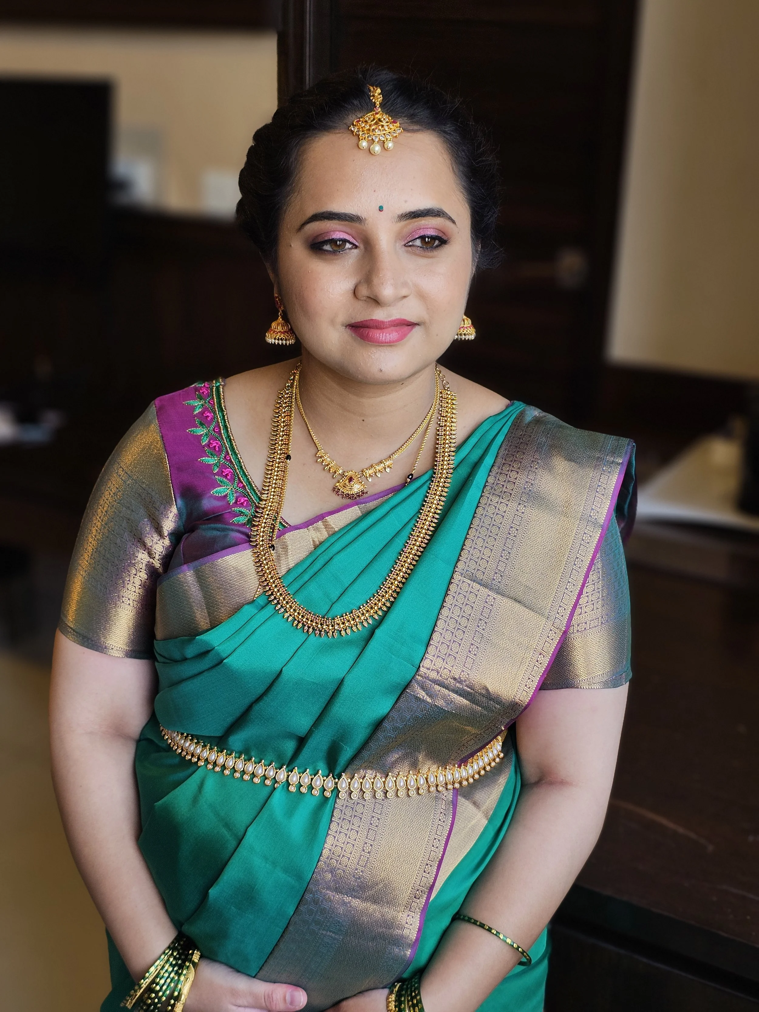 Woman in a traditional Indian saree with gold jewelry