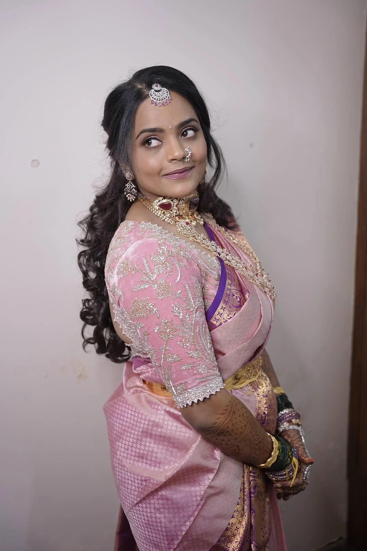 South Indian bride smiling after natural bridal makeup application in Bangalore studio