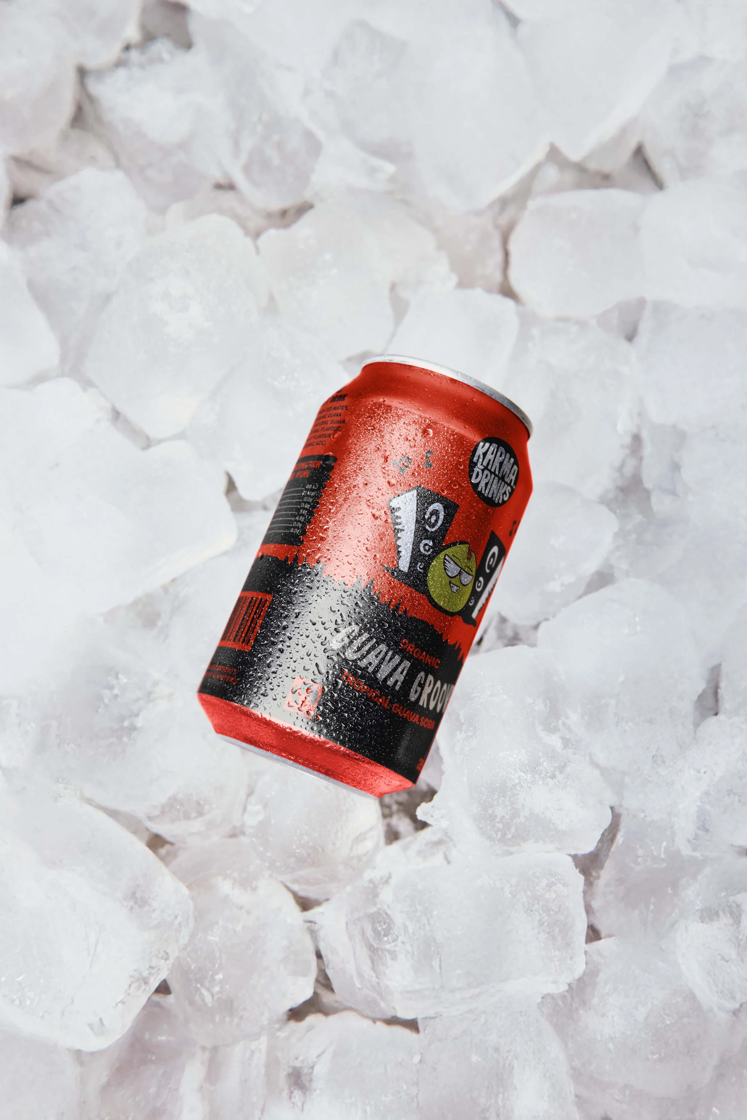 A can of organic sparkling guava soda resting on ice cubes.