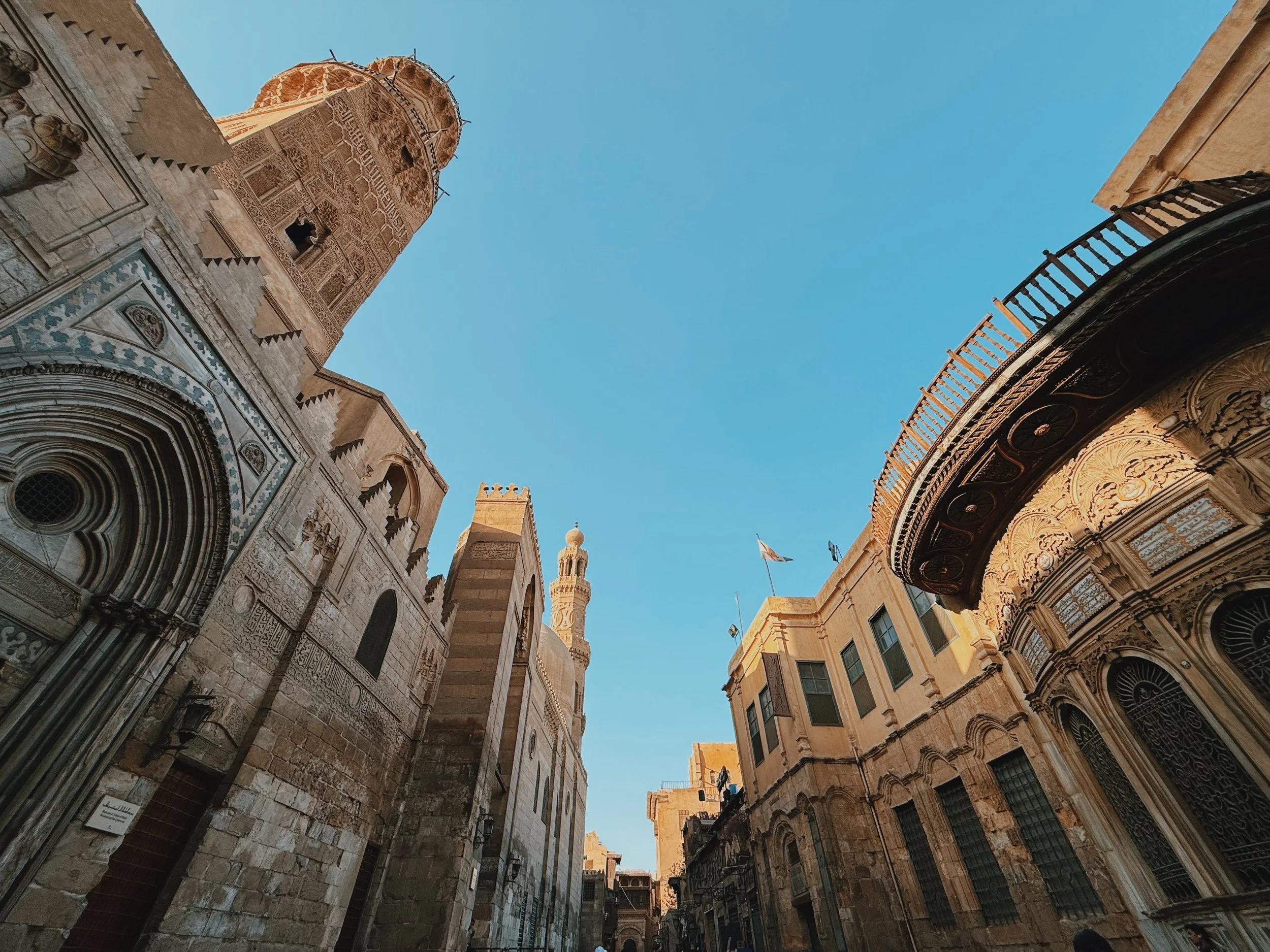 Mamluk mosques and minarets lining Al-Muizz Street in Islamic Cairo.