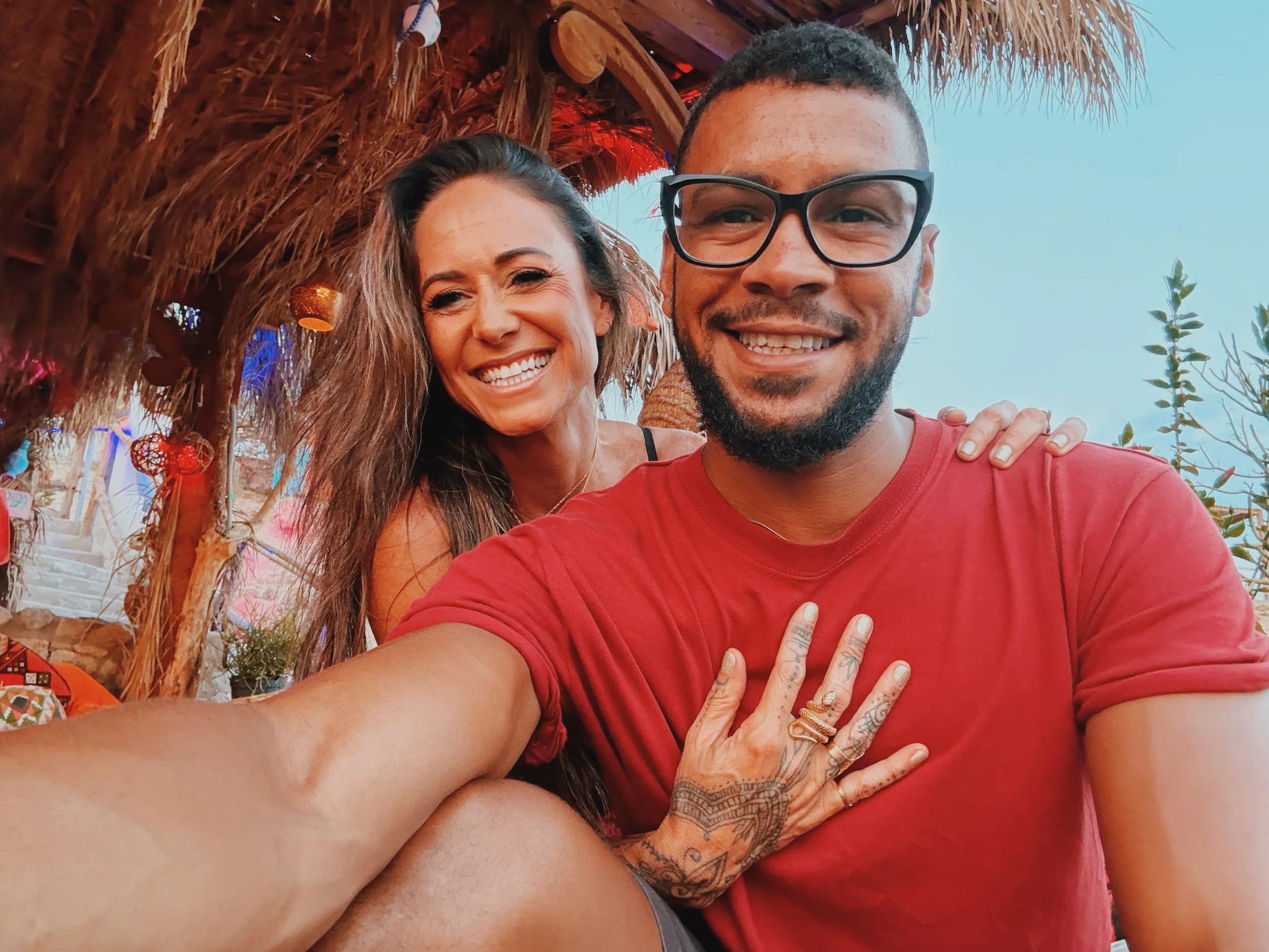 Jennifer and Mostafa of Takemet Tours smiling under the palm-thatched roof of Basata Cafe in Sharm El Sheikh