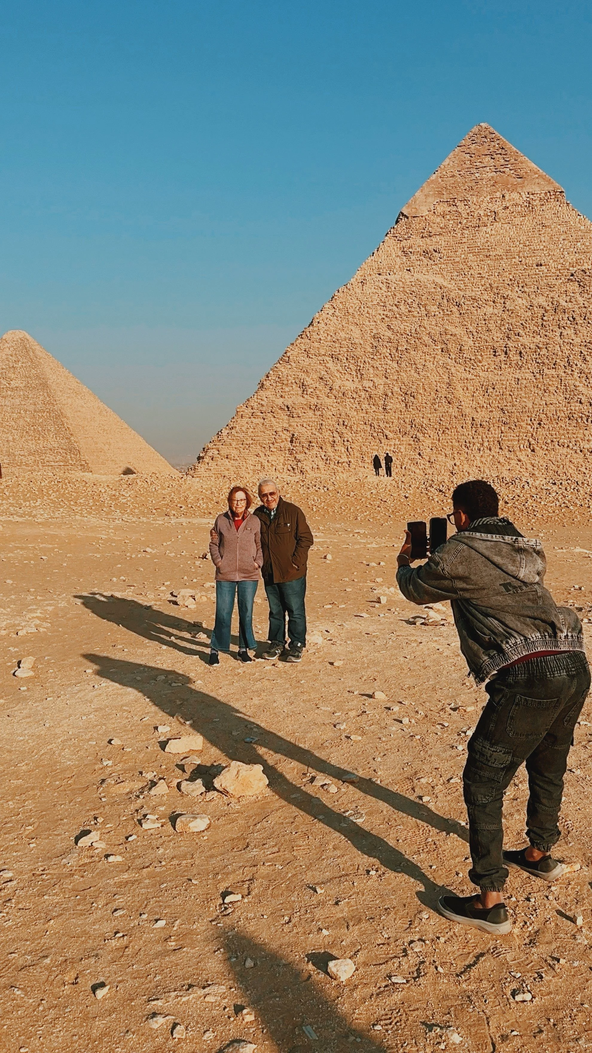 Mostafa photographing two guests in front of the Pyramid of Khafre at Giza.