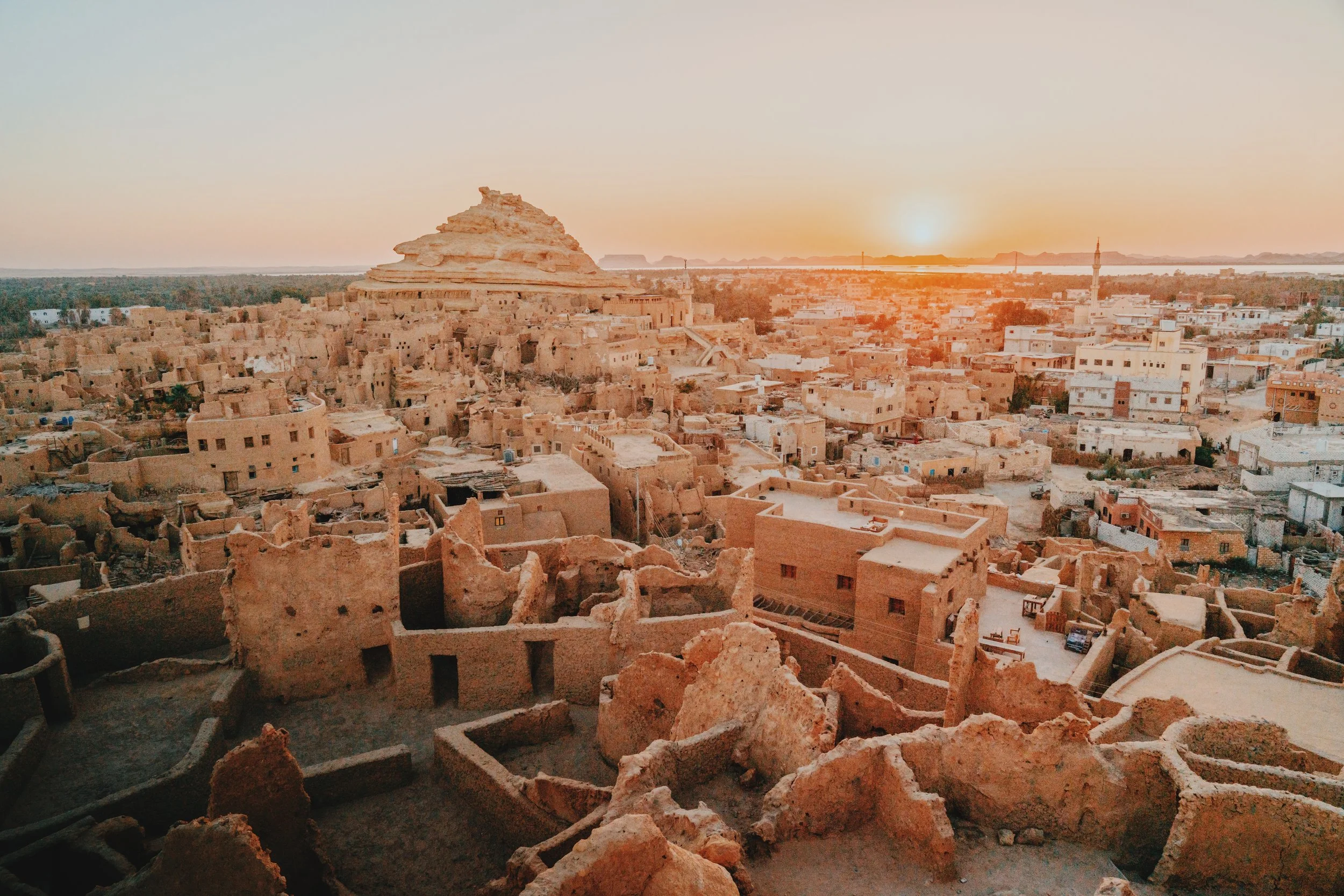 The mud-brick ruins of the old Shali fortress overlooking Siwa Oasis at sunset.