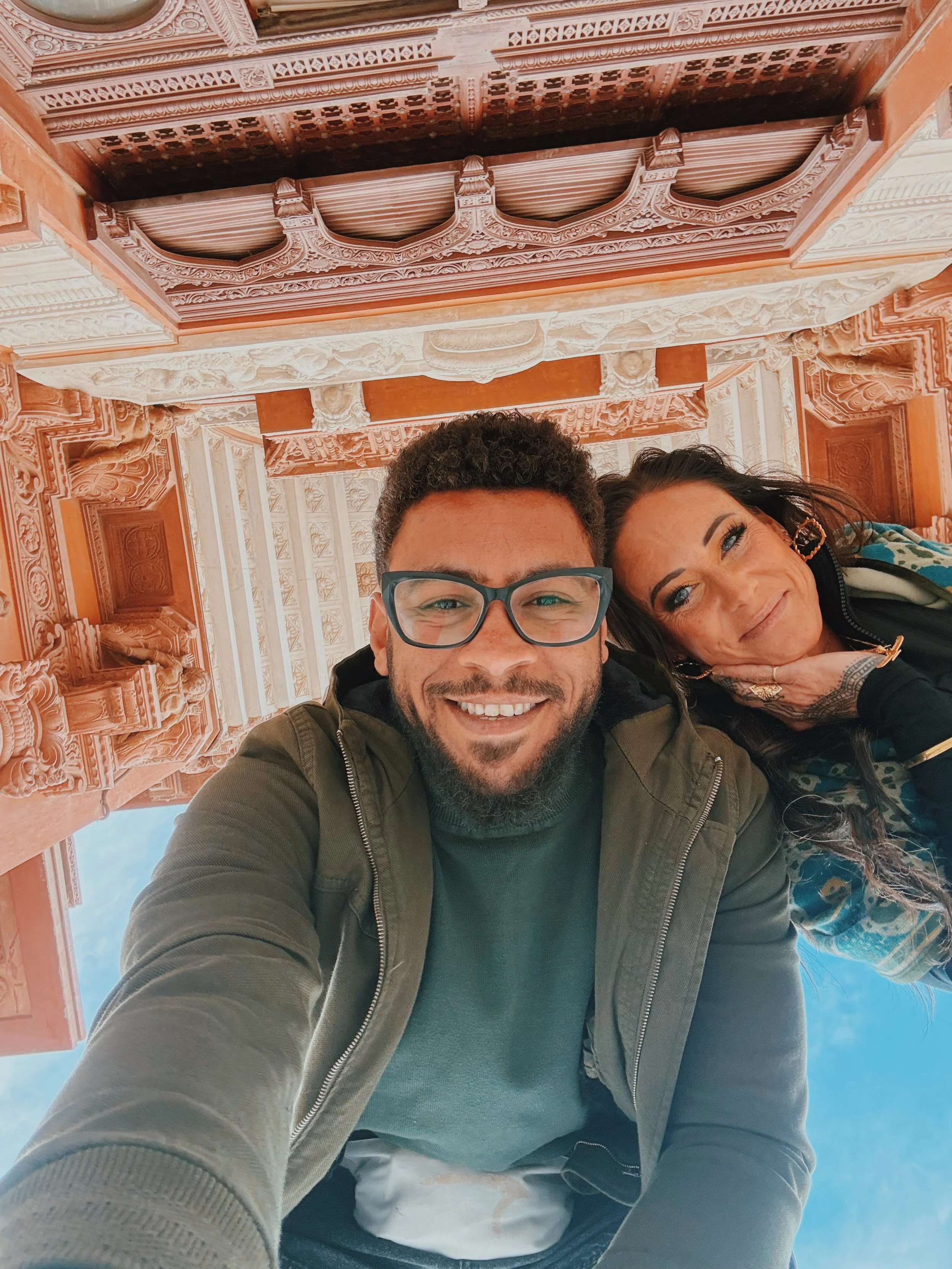 Jennifer and Mostafa of Takemet Tours taking a selfie inside an ornate historic building in Egypt.