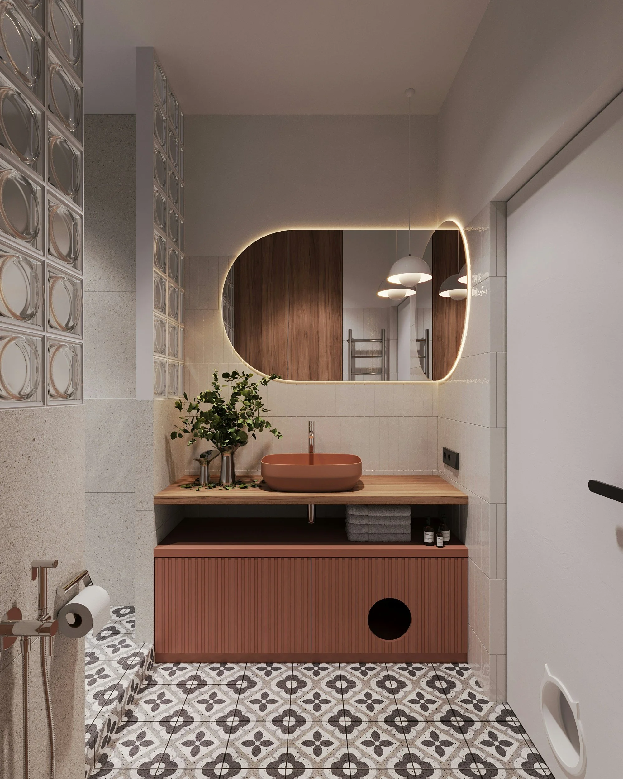 Modern bathroom with patterned floor tiles, a pink vanity with a round sink, a large backlit mirror, hanging pendant lights, a potted plant, a towel, and a wall-mounted towel rack.