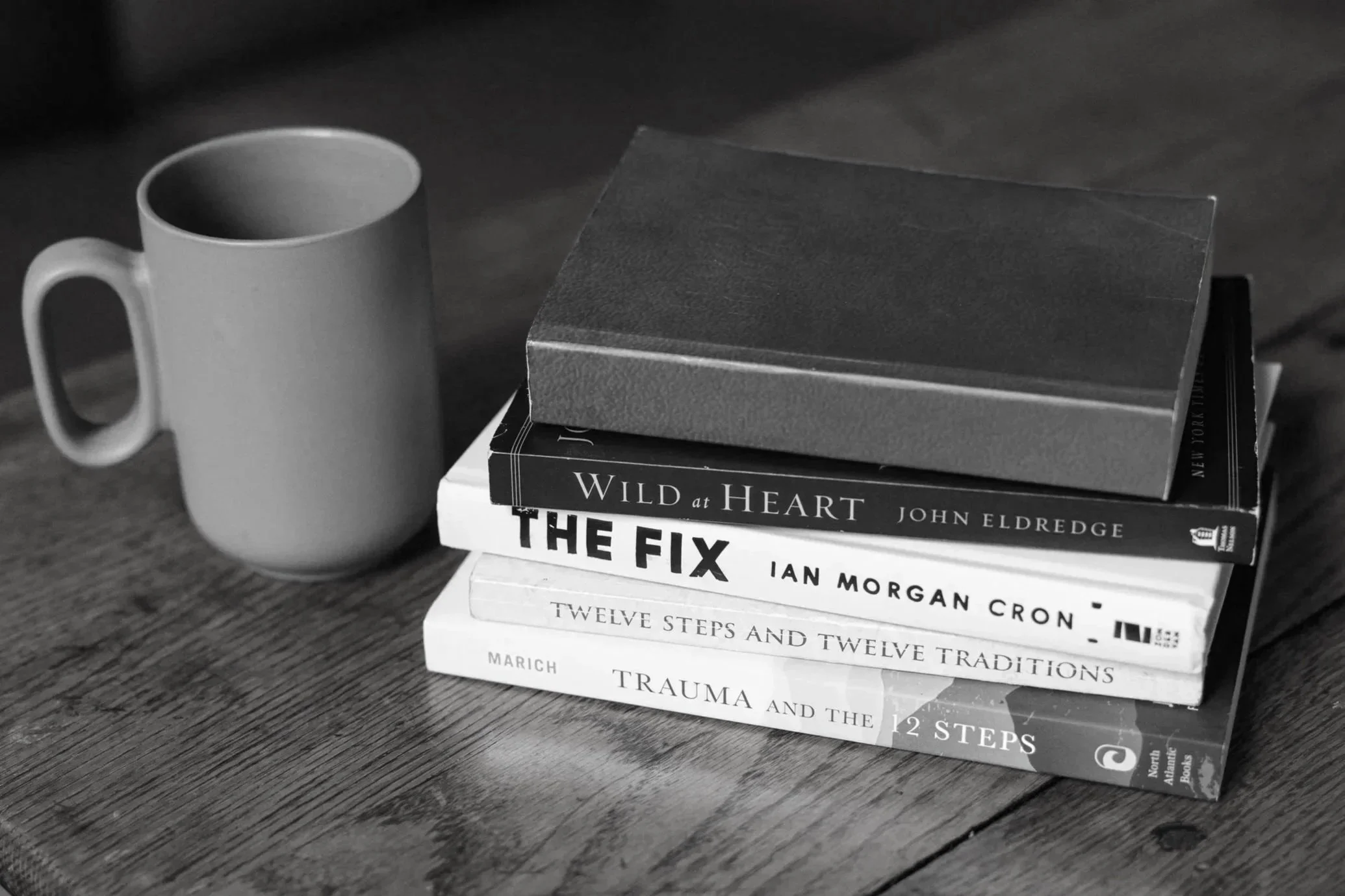 Therapy for men books on recovery and coping strategies placed on a table in a counseling office in Nashville