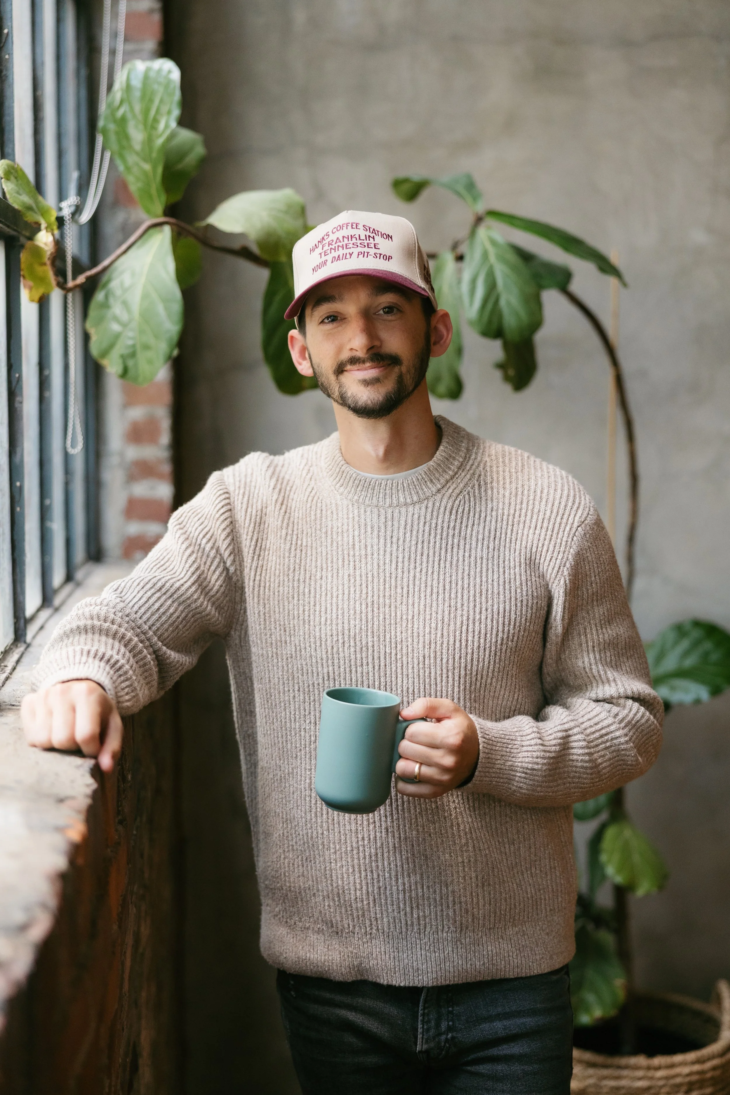 Nashville therapist Brayden Hanks holding a coffee mug in a relaxed setting