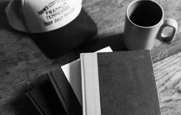 Books for men's issues on a table in nashville therapy office representing personal growth and self-trust work