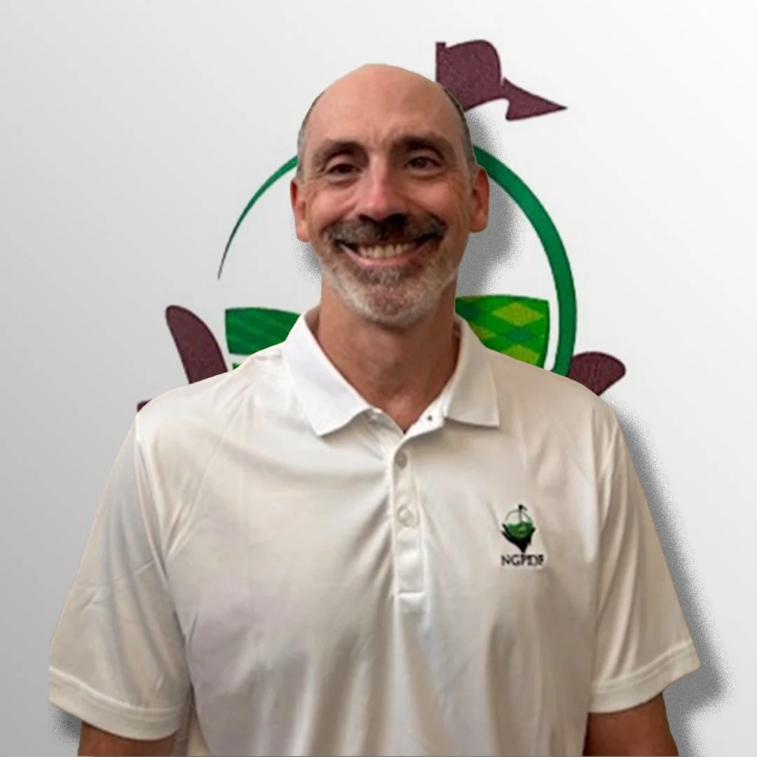 A smiling man in a white polo shirt standing in front of a logo featuring a golf course and a golf flag.