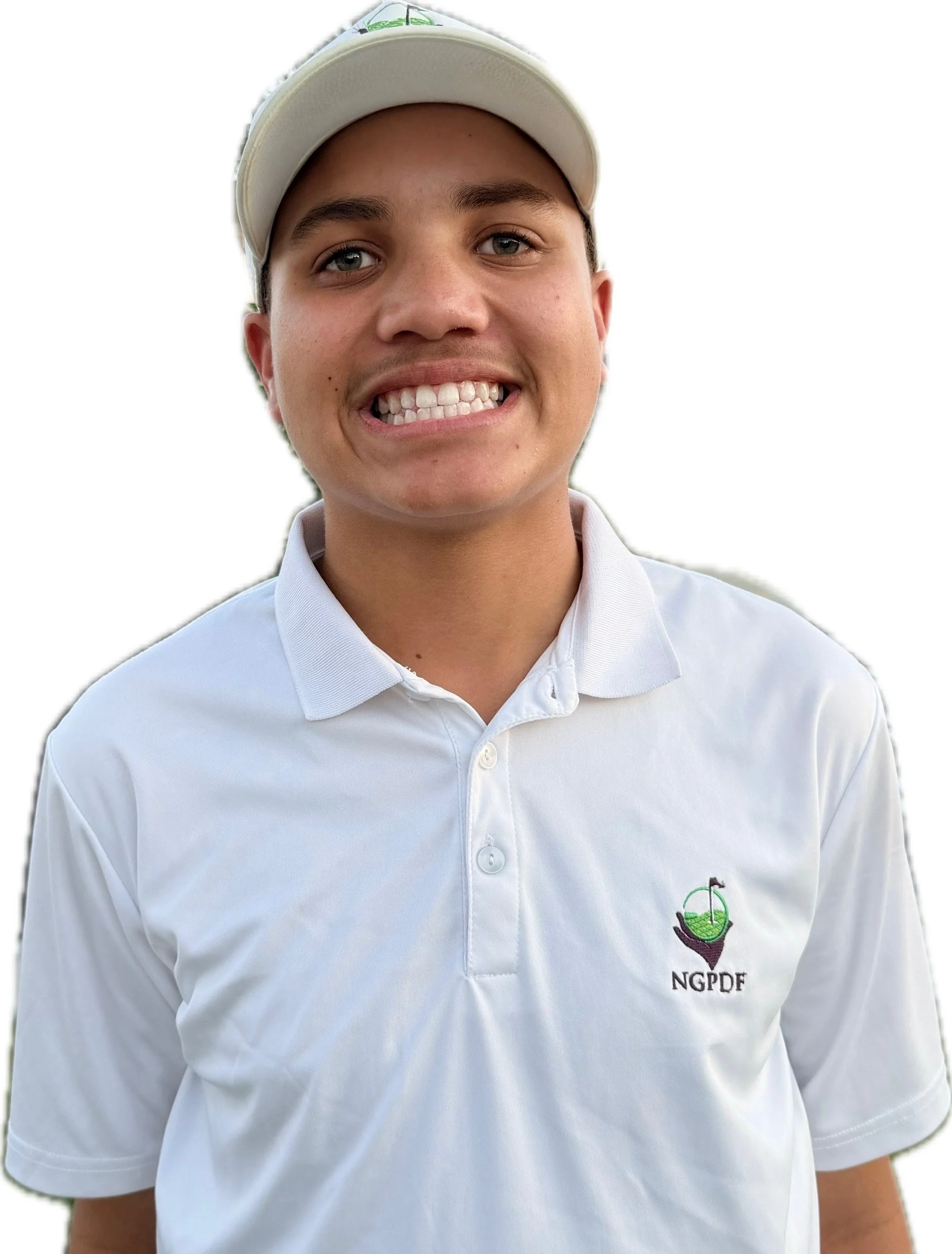 Close-up of a smiling young boy wearing a white baseball cap and a light blue shirt outdoors.