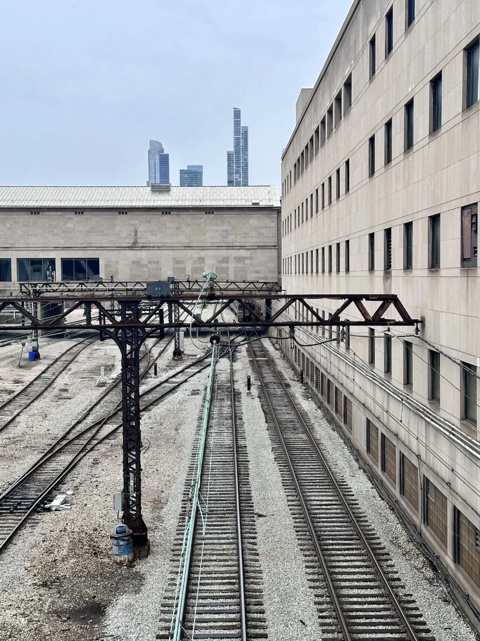 NEMA Chicago's stacked rectangular volumes rising above railway tracks, echoing the form of the Willis Tower.