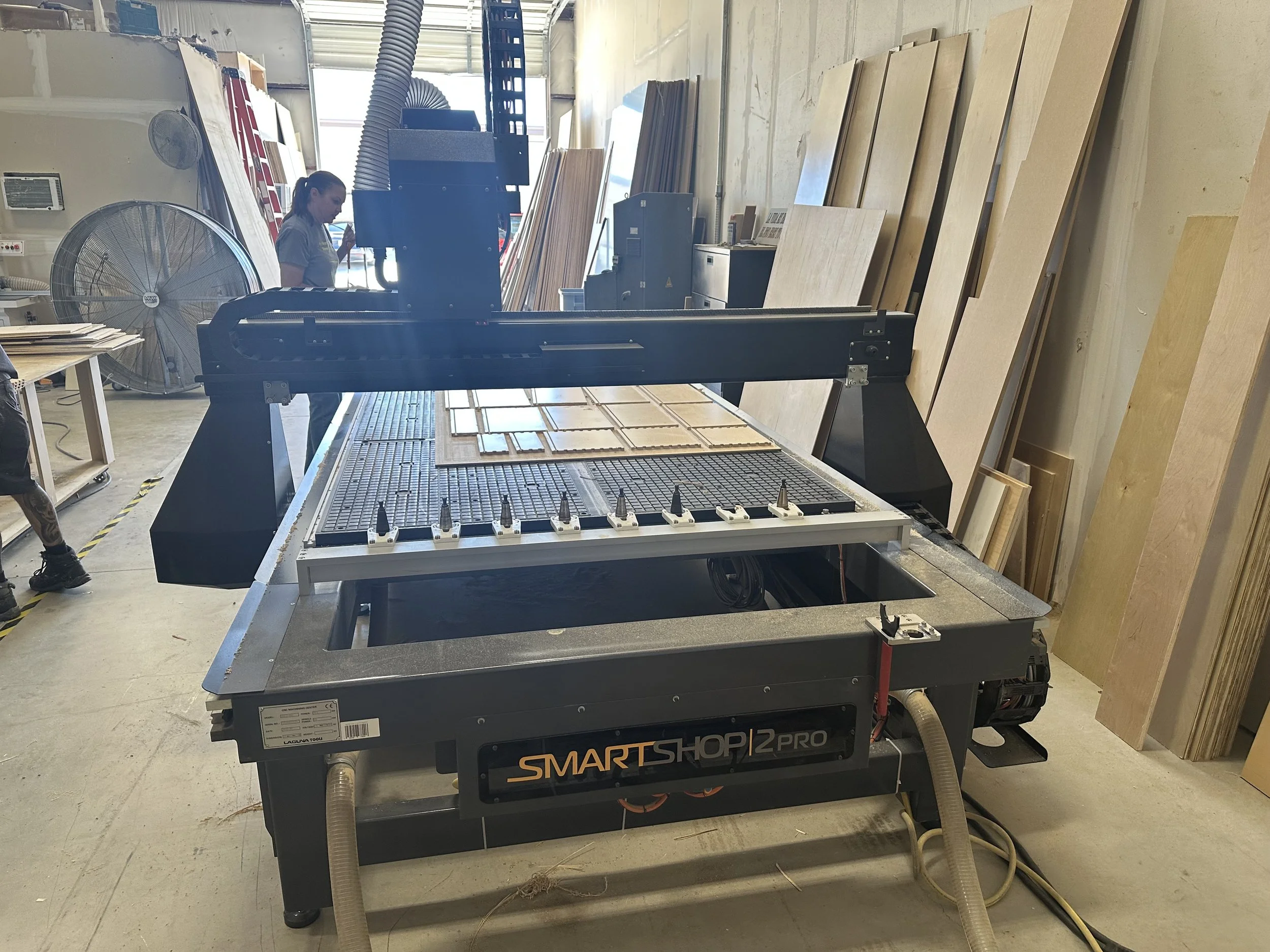 CNC router cutting machine with pieces of wood around it