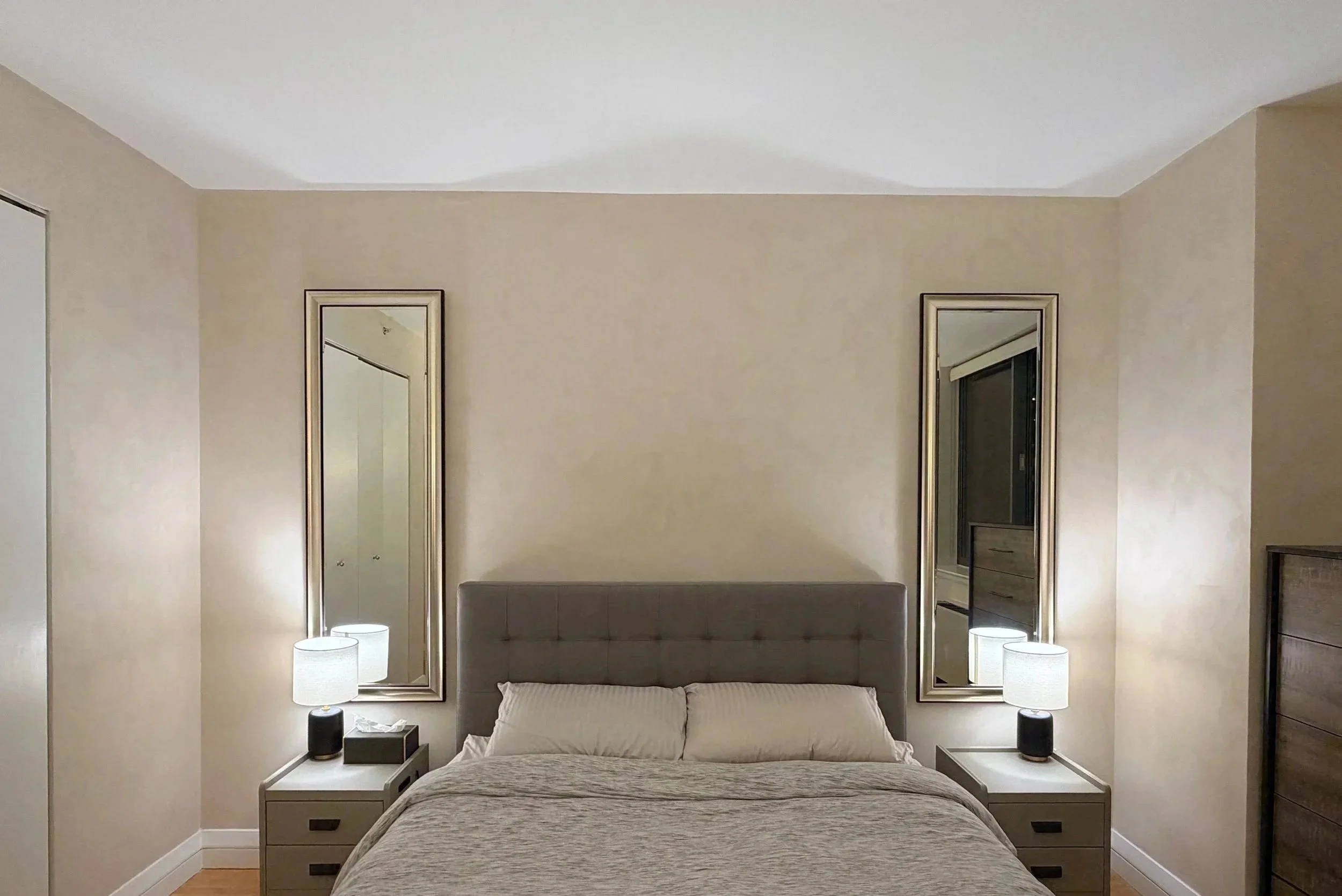 Limewash bedroom at night with warm lamp light — Nomad apartment | Limewall & Co.