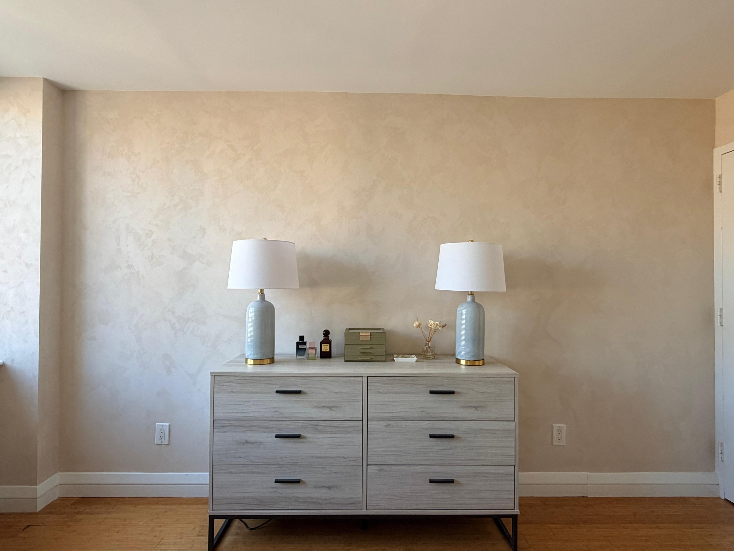 Warm cream limewashed bedroom wall with mid-century dresser — Nomad, Manhattan, by Limewall & Co.