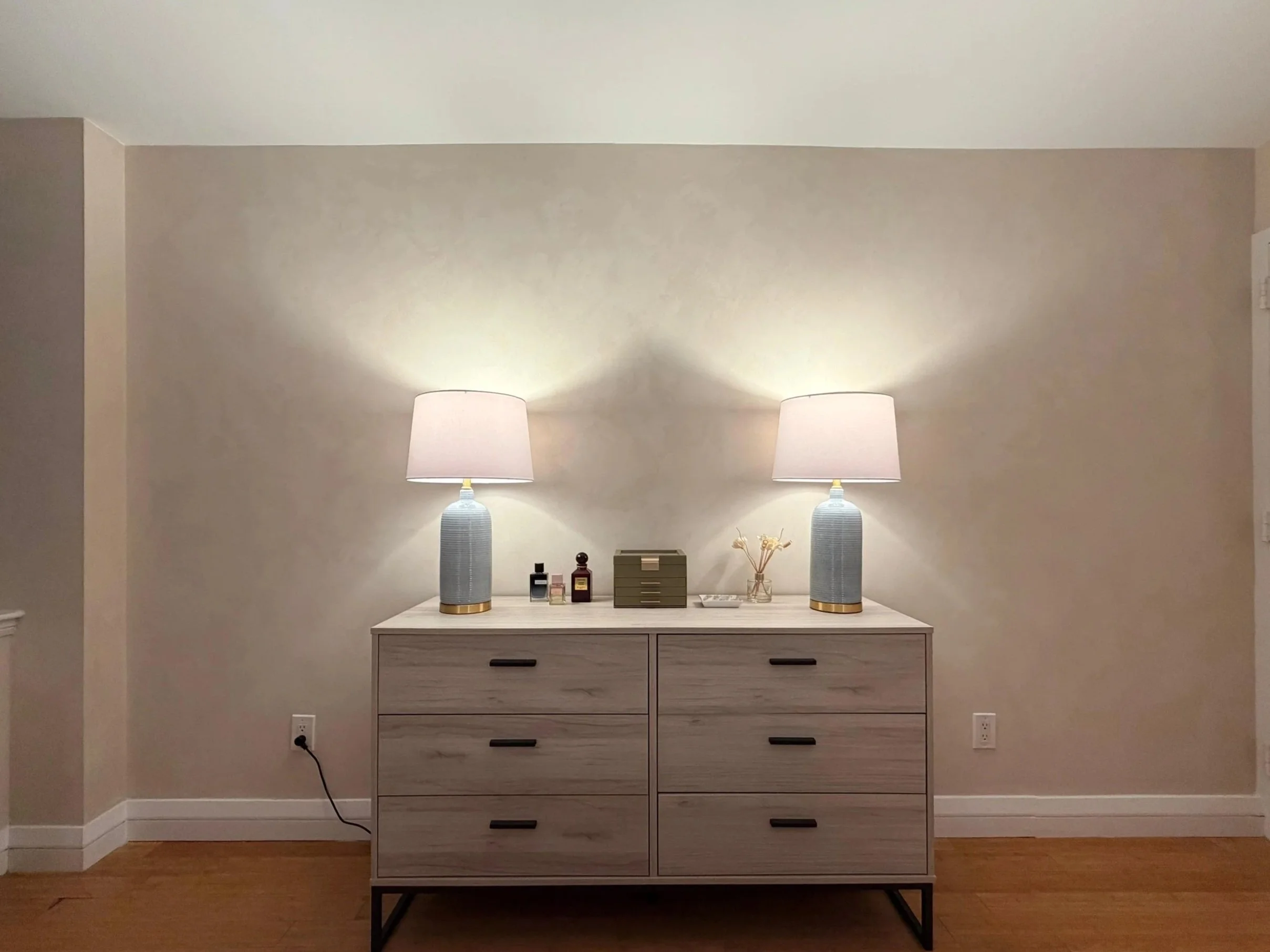 Limewash dresser wall with table lamps in evening light — Nomad bedroom | Limewall & Co.