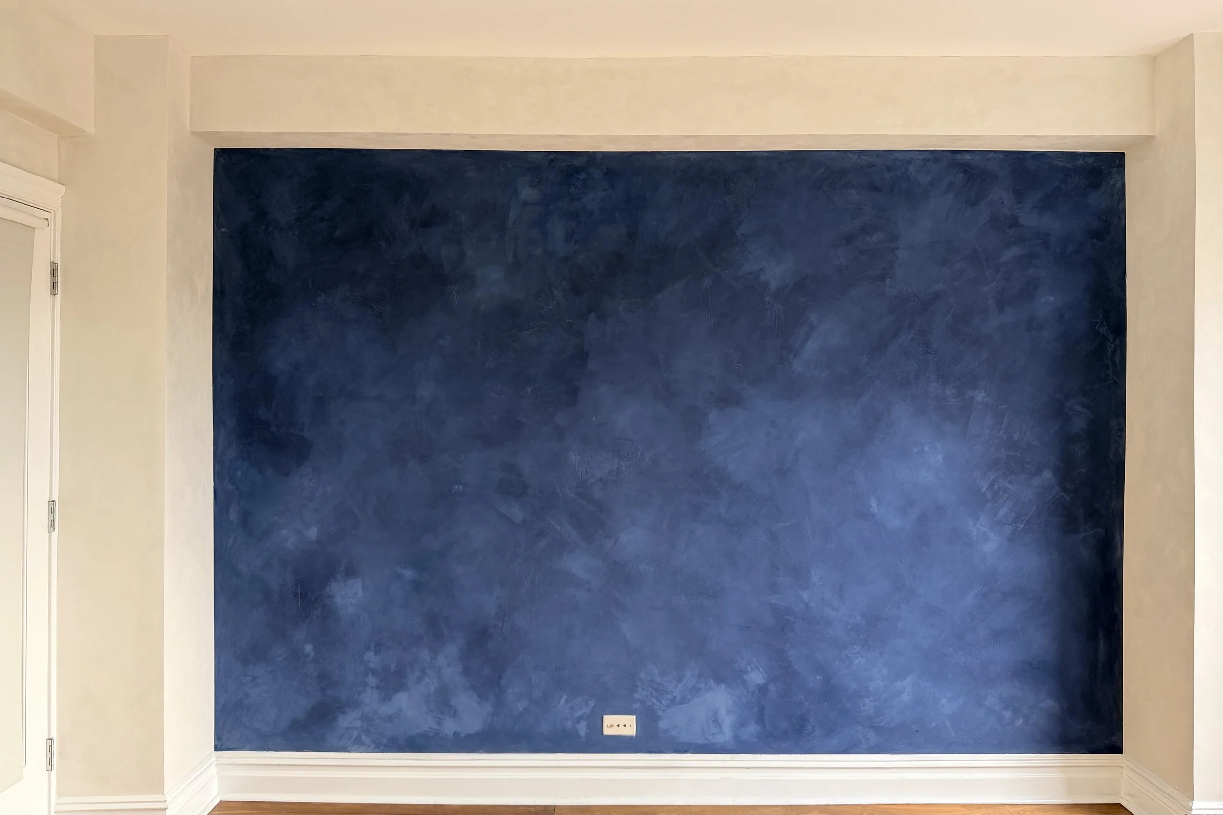 Deep navy limewash accent wall at dusk — Greek Islands, West Village project by Limewall & Co.