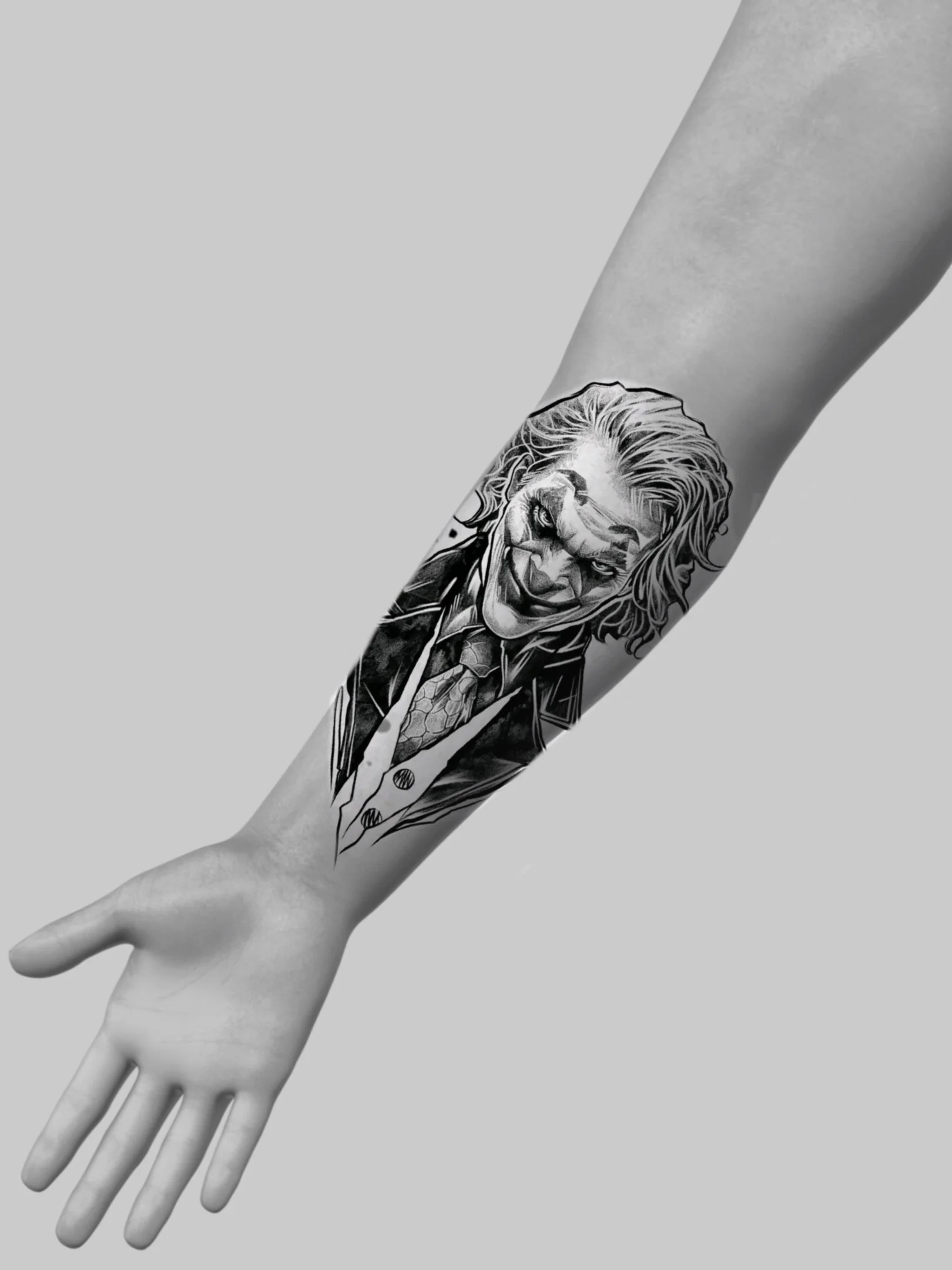 Black and white tattoo of the Joker from Batman on a person's forearm, showing his face with a sinister smile and wild hair.