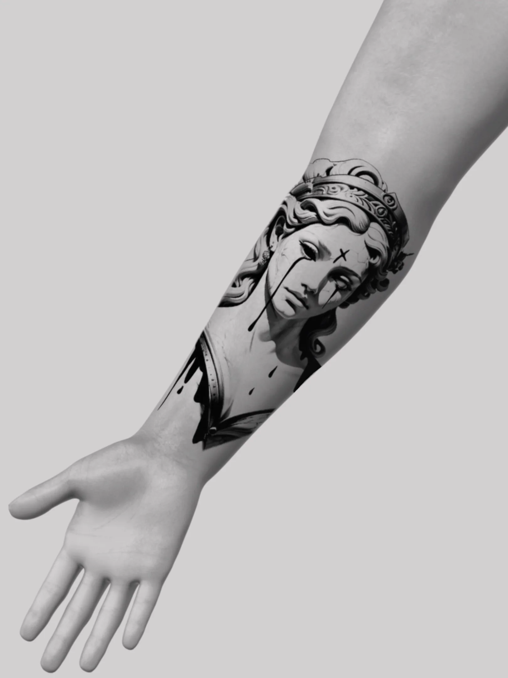 Black and white tattoo of a classical woman's face with a crown on her head on a person's forearm.