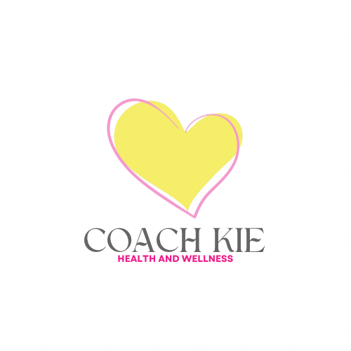 A logo featuring a yellow heart outline with a pink border, with the text 'COACH KIE' below it, and 'HEALTH AND WELLNESS' written underneath in pink.