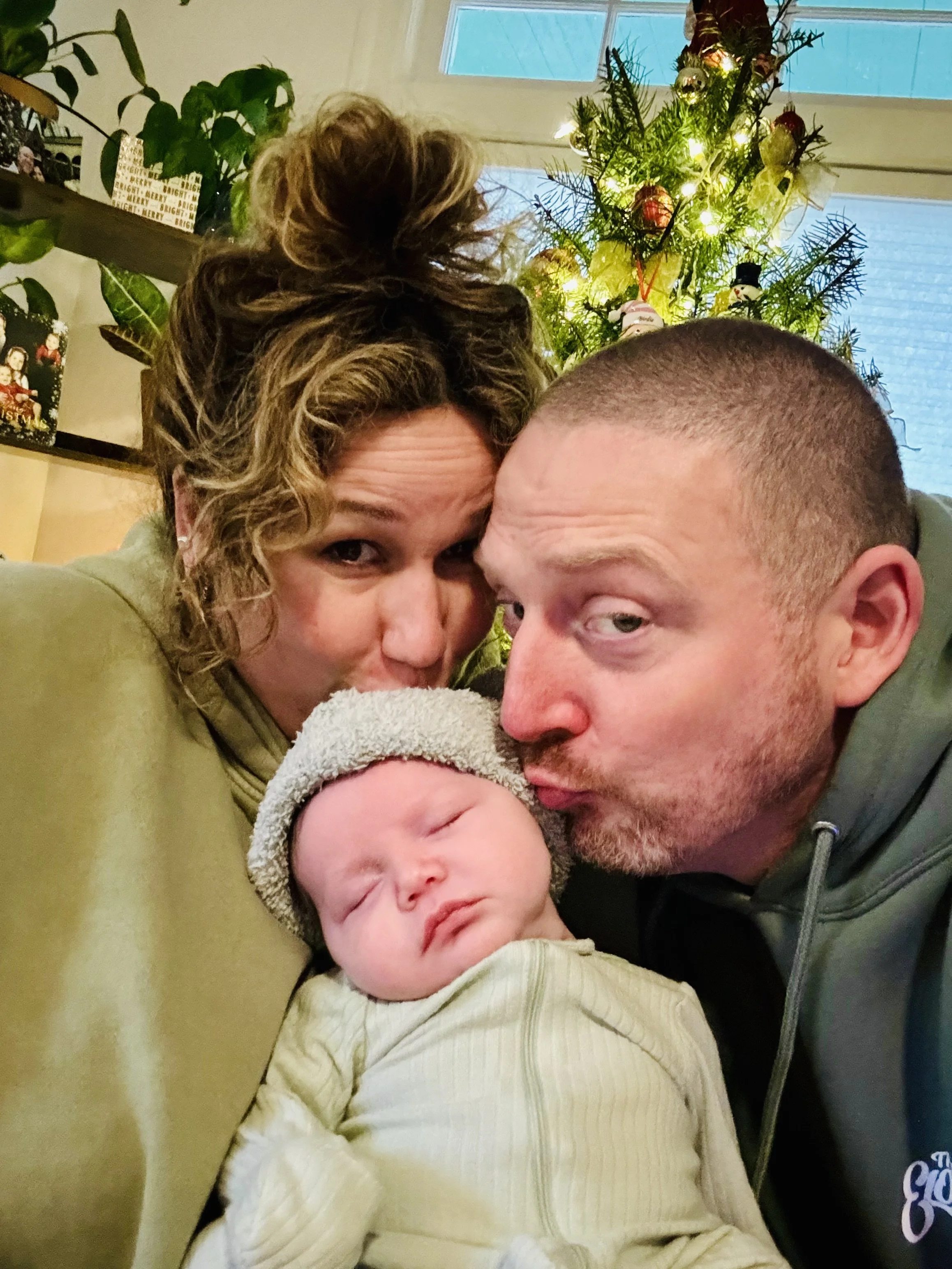 Haley Foulkes with her husband and baby — birth and postpartum doula, mother, and holistic postpartum support provider in Renton, Washington.