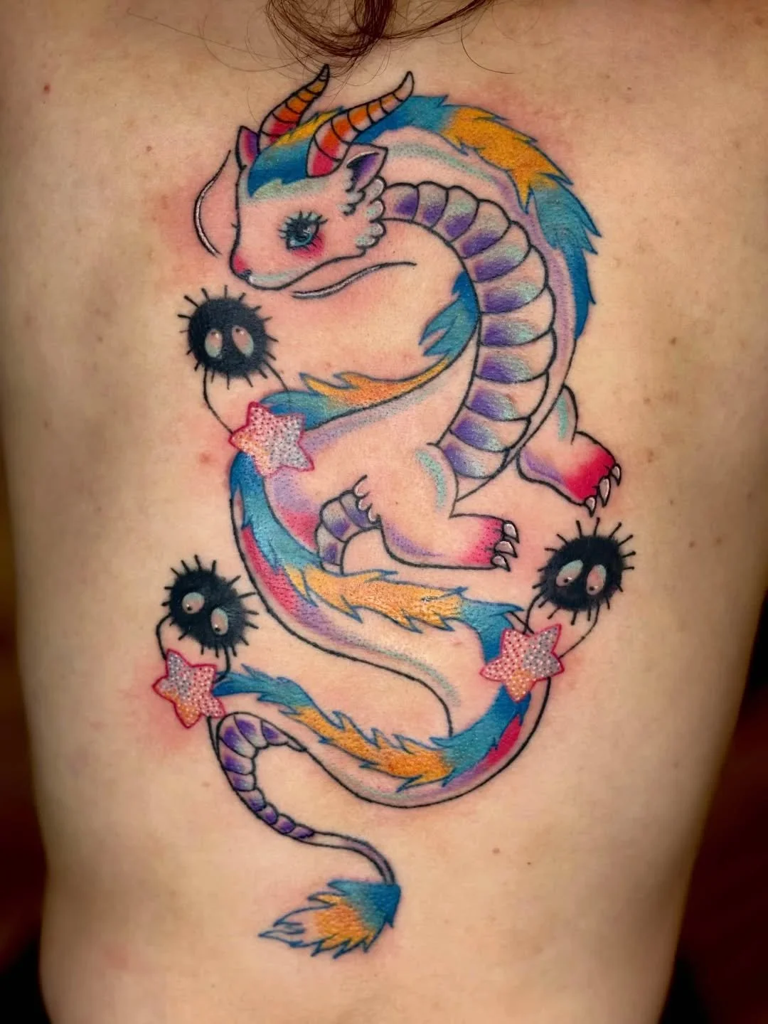 @olivia.zheta tattooed this super cute Haku back piece from Spirited away. They are currently booking February and just adore doing color but also love a good black and grey piece. Send an inquiry today to book ✨Link bio to book✨