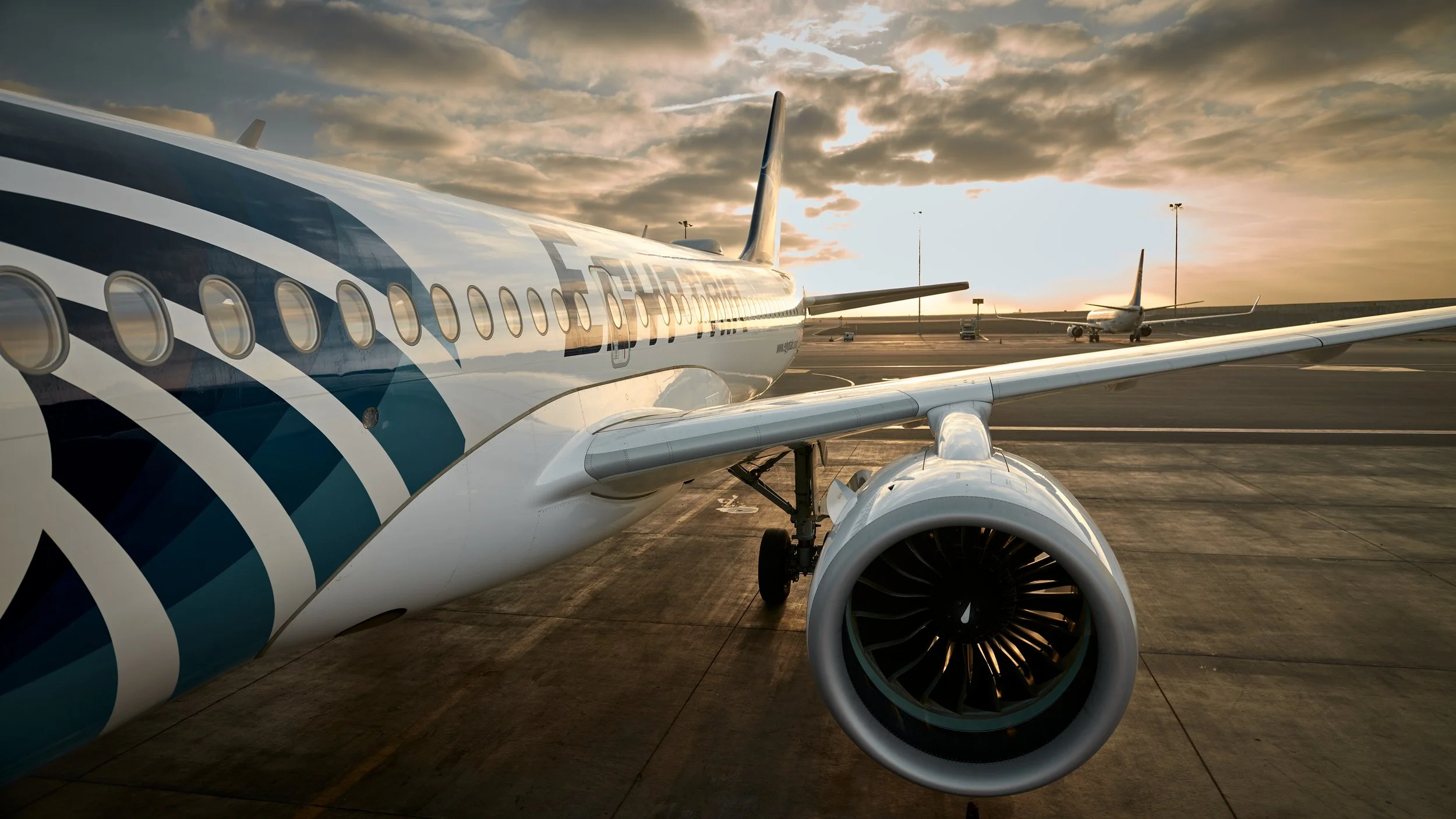 An EgyptAir plane framed against the warm glow of the sunset