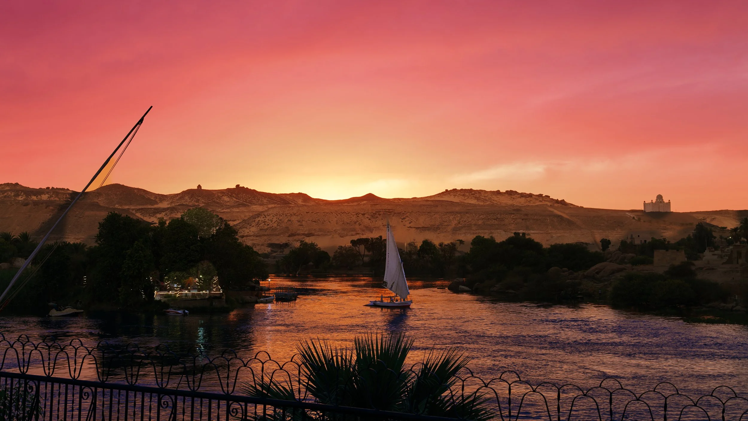 Gorgeous Nile River at Aswan, glowing under the warm hues of sunset.
