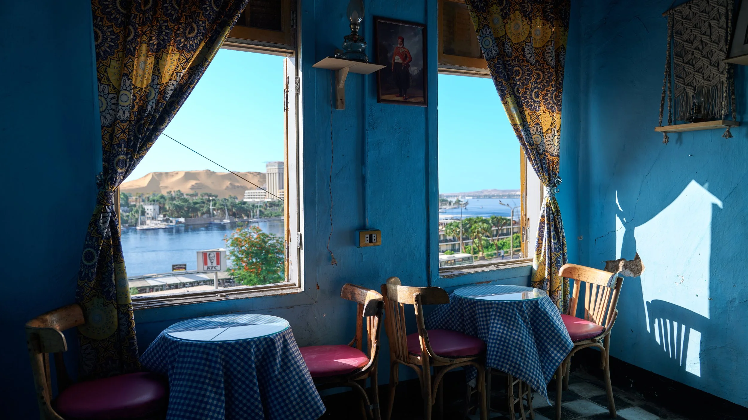 A café in Aswan with windows opening to a tranquil view of the Nile River