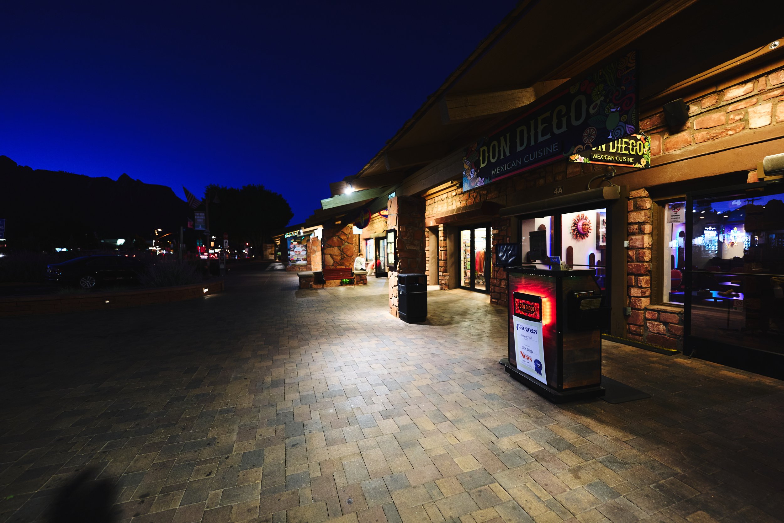 Uptown Sedona’s lively walking street, lined with charming shops, art galleries, and inviting restaurants against a stunning red rock backdrop.
