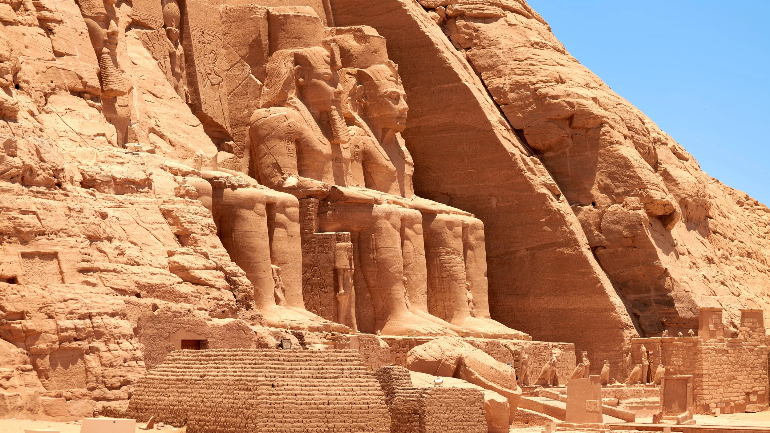 Majestic Abu Simbel, where towering statues rise proudly from the desert sands.
