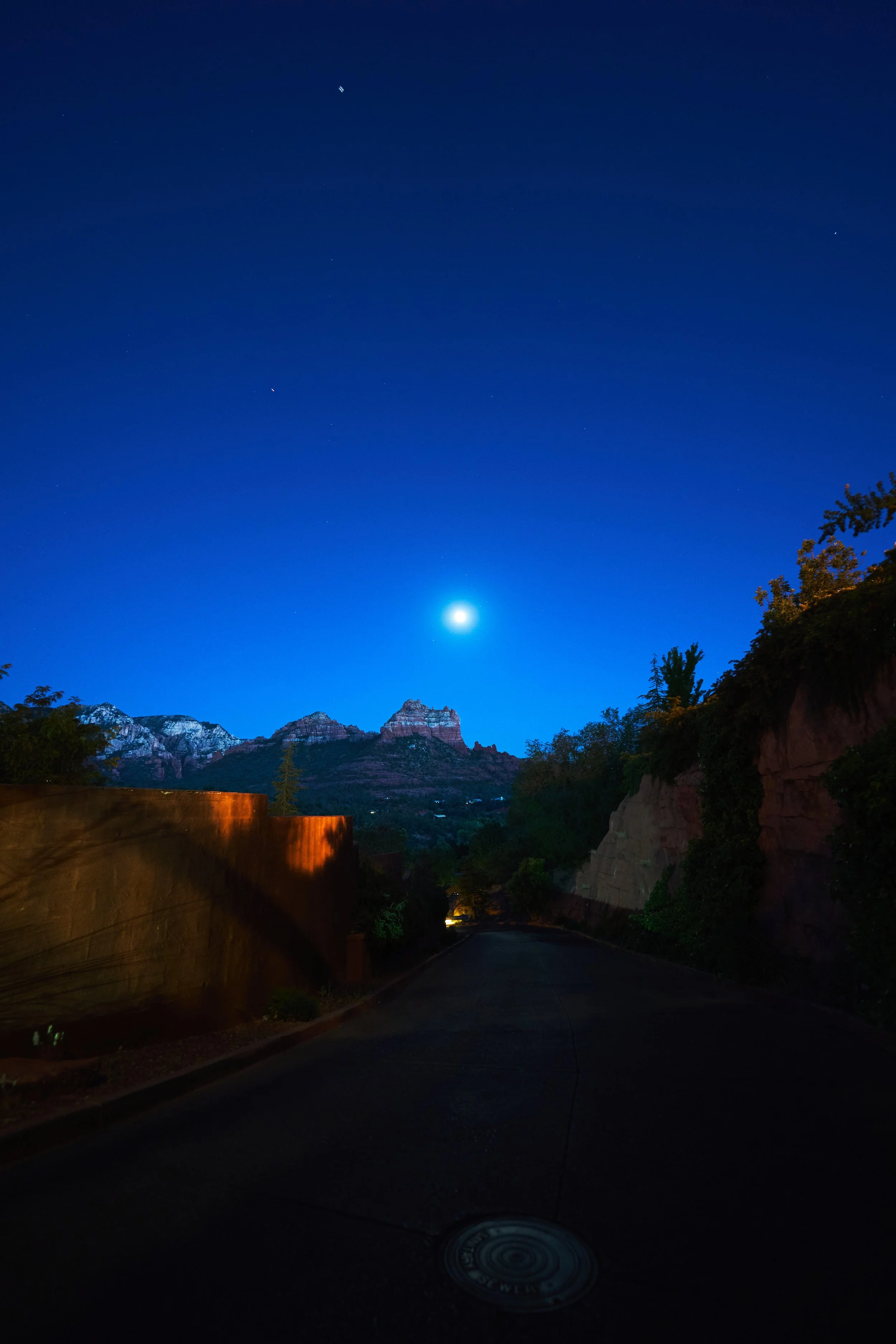 Moonlit view in Sedona, where soft silver light bathes the mountains in a magical glow.
